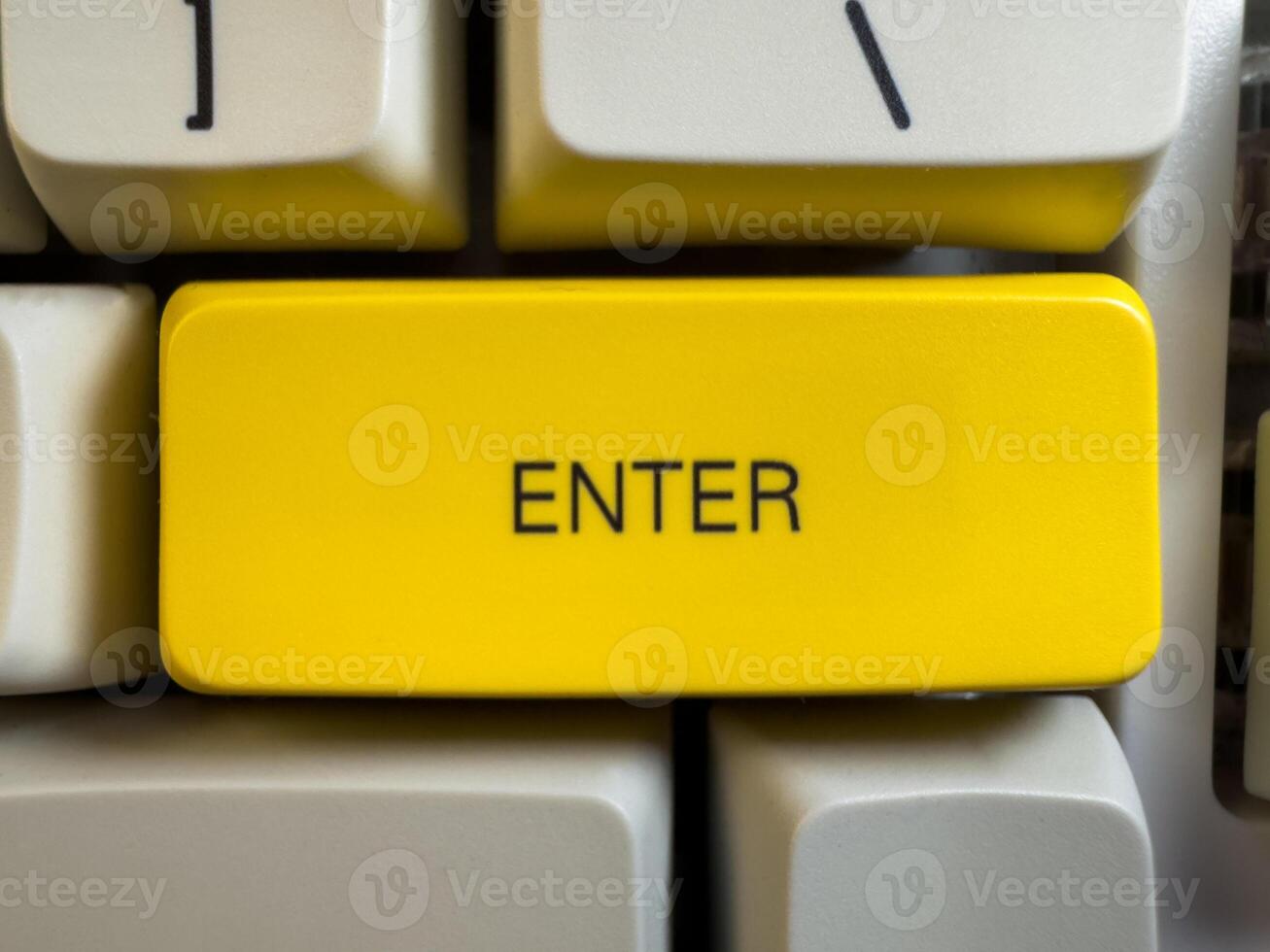 Large yellow Enter button on mechanical white keyboard for programmers with gray shades and red switches, flay lay photo