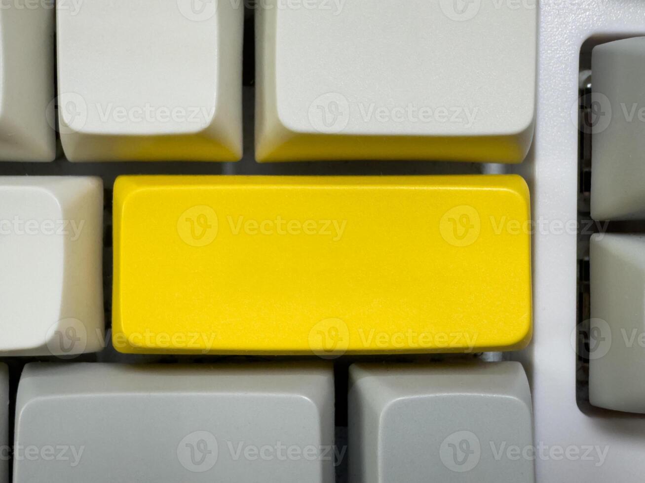 Big yellow Enter button on mechanical white keyboard, business concept, for advertising, for banners photo