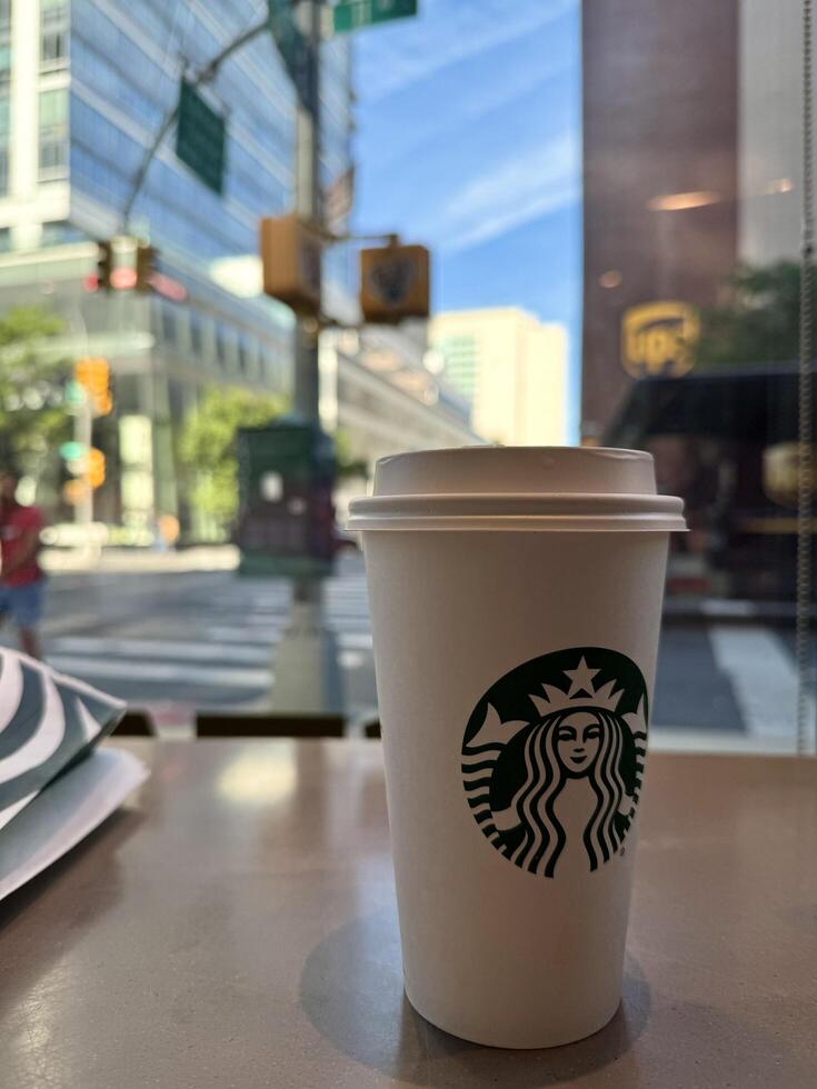 New York, USA - September 11, 2024 Close up of a tall Starbucks coffee in Starbucks coffee shop photo