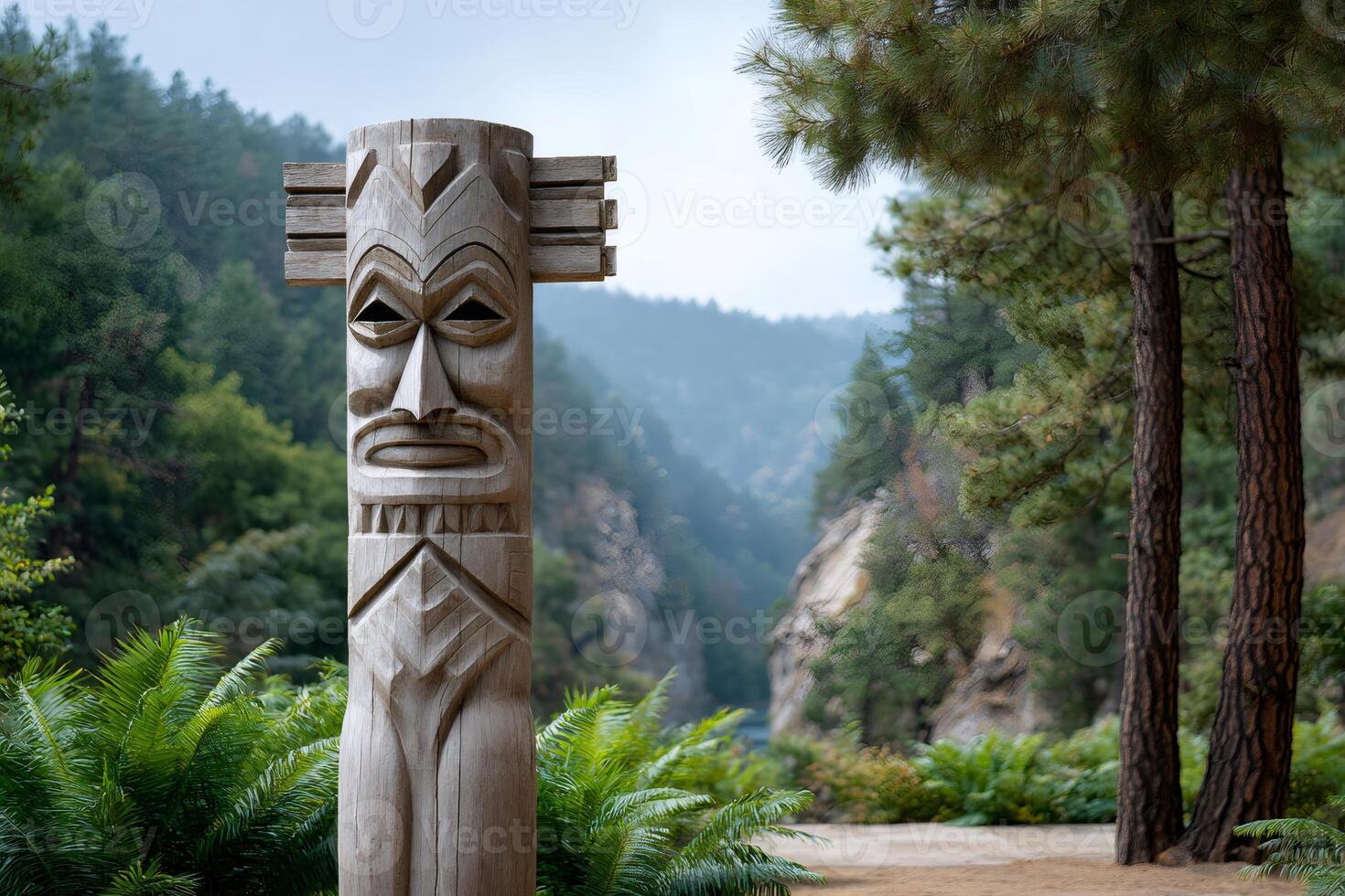 Wooden totem pole standing in front of a canyon photo