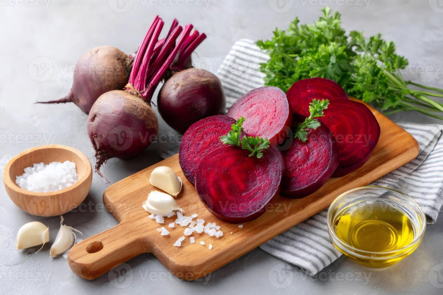 Sliced beetroot with garlic, parsley, salt and olive oil on gray background photo