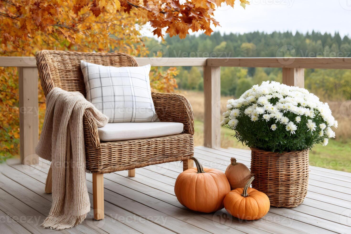 Cozy autumn composition on a terrace with wicker armchair, blanket, pumpkins and flowers photo