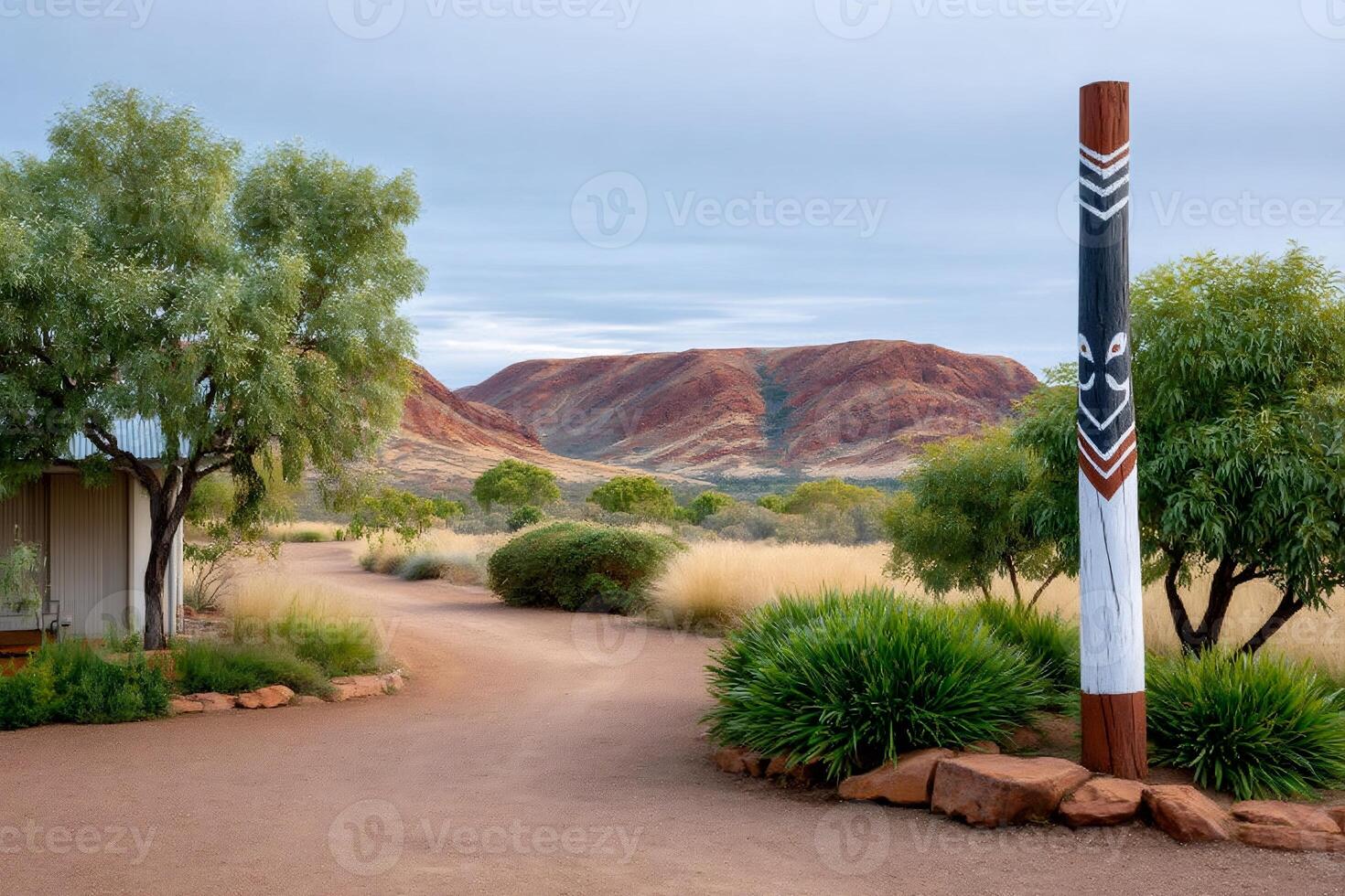Gravel path leading to a cabin with aboriginal puti and the Hamersley Range in the background photo