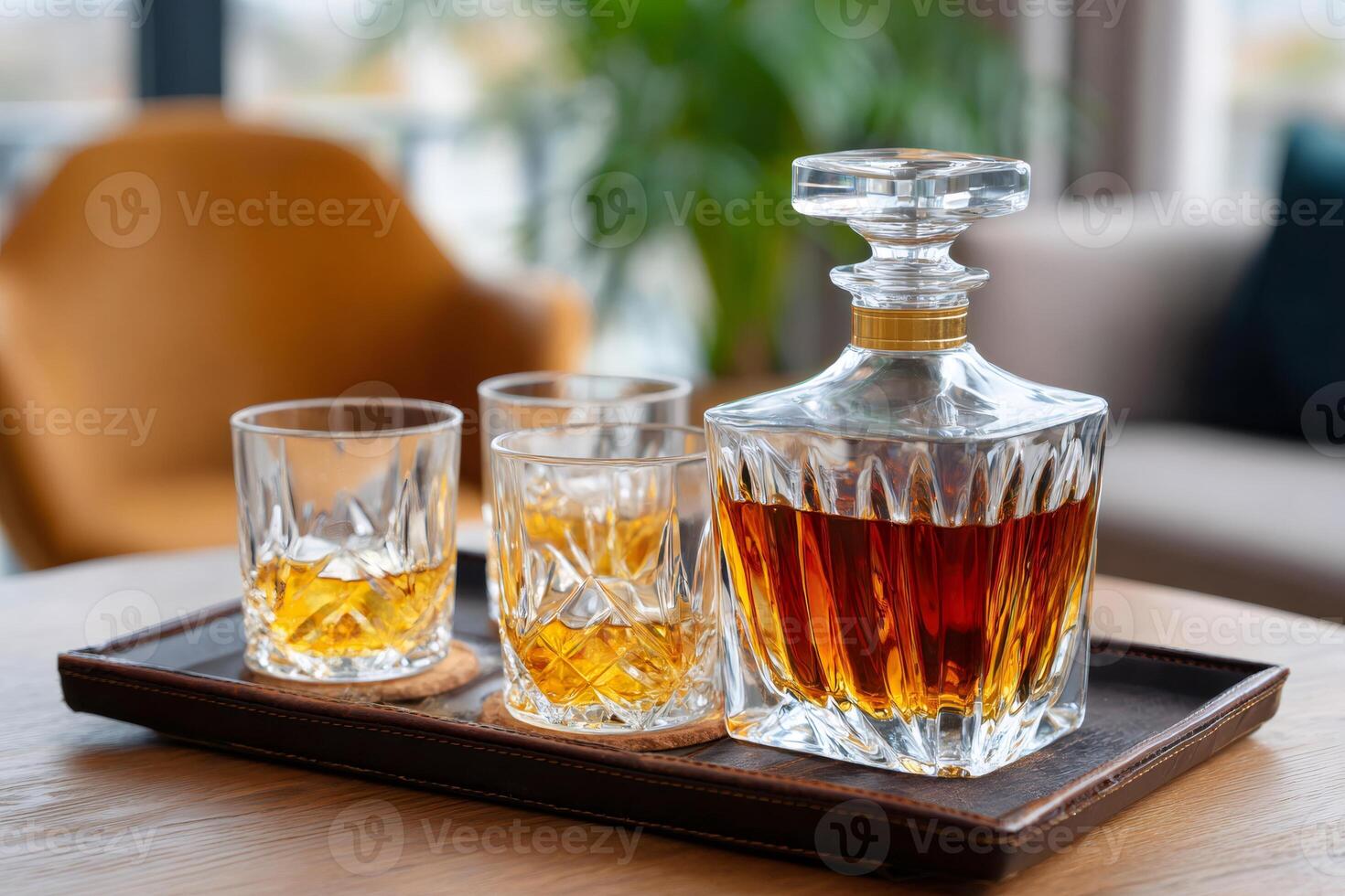 Crystal decanter and glasses with whiskey resting on elegant serving tray photo