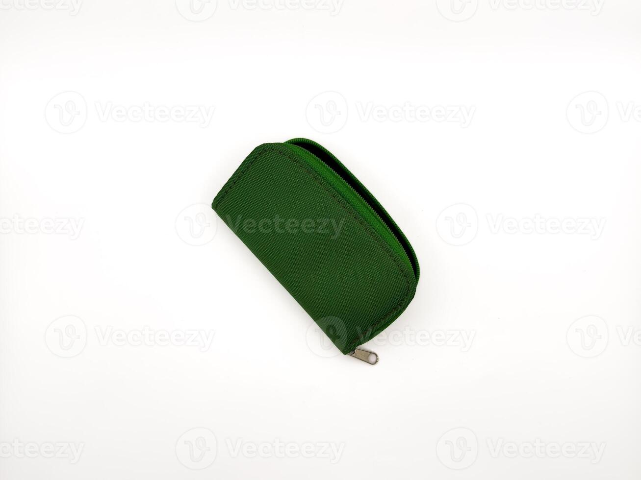 Small green fabric wallet with zipper on white background. copy space, flay lay, top view photo