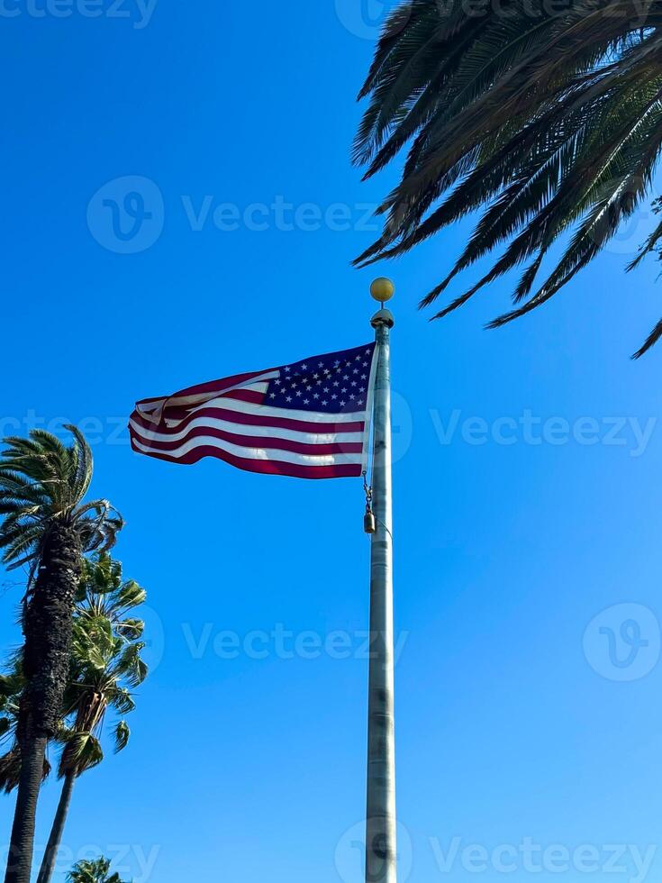 USA American flag flying against Blue Sky in California, LA photo