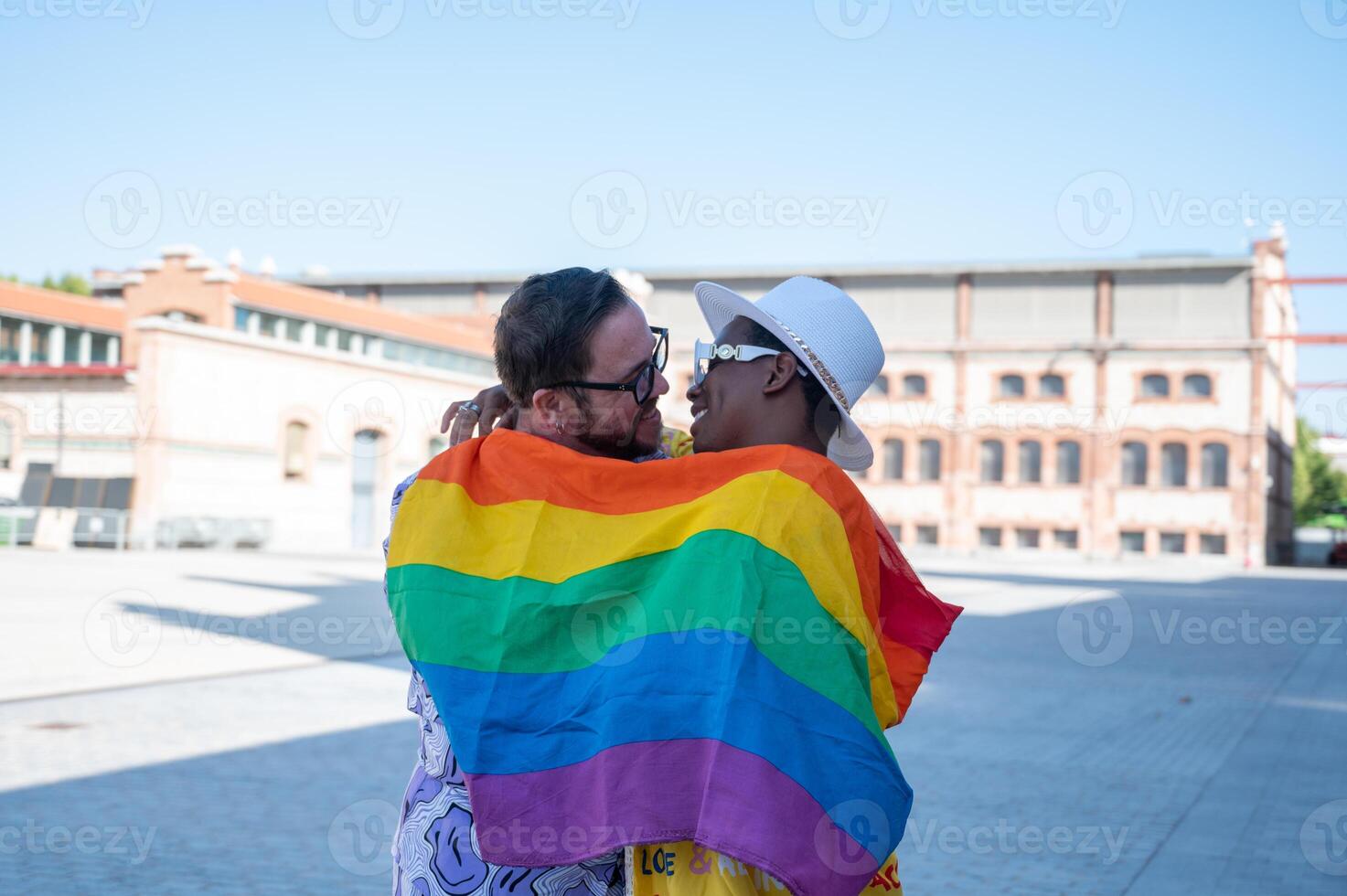 Portrait of a multi-ethnic gay couple raising lgbt flag.2 photo