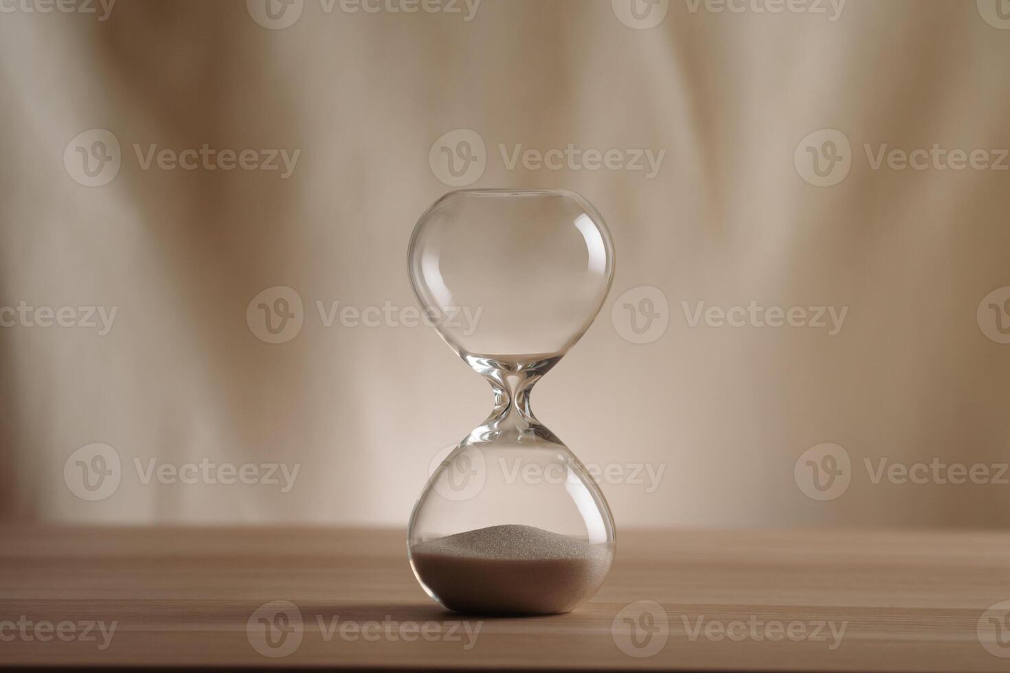 A simple hourglass on a wooden table with a beige backdrop, symbolizing time flow and minimalistic living. Represents timeless themes in a creative, uncluttered presentation for stylish concepts. photo