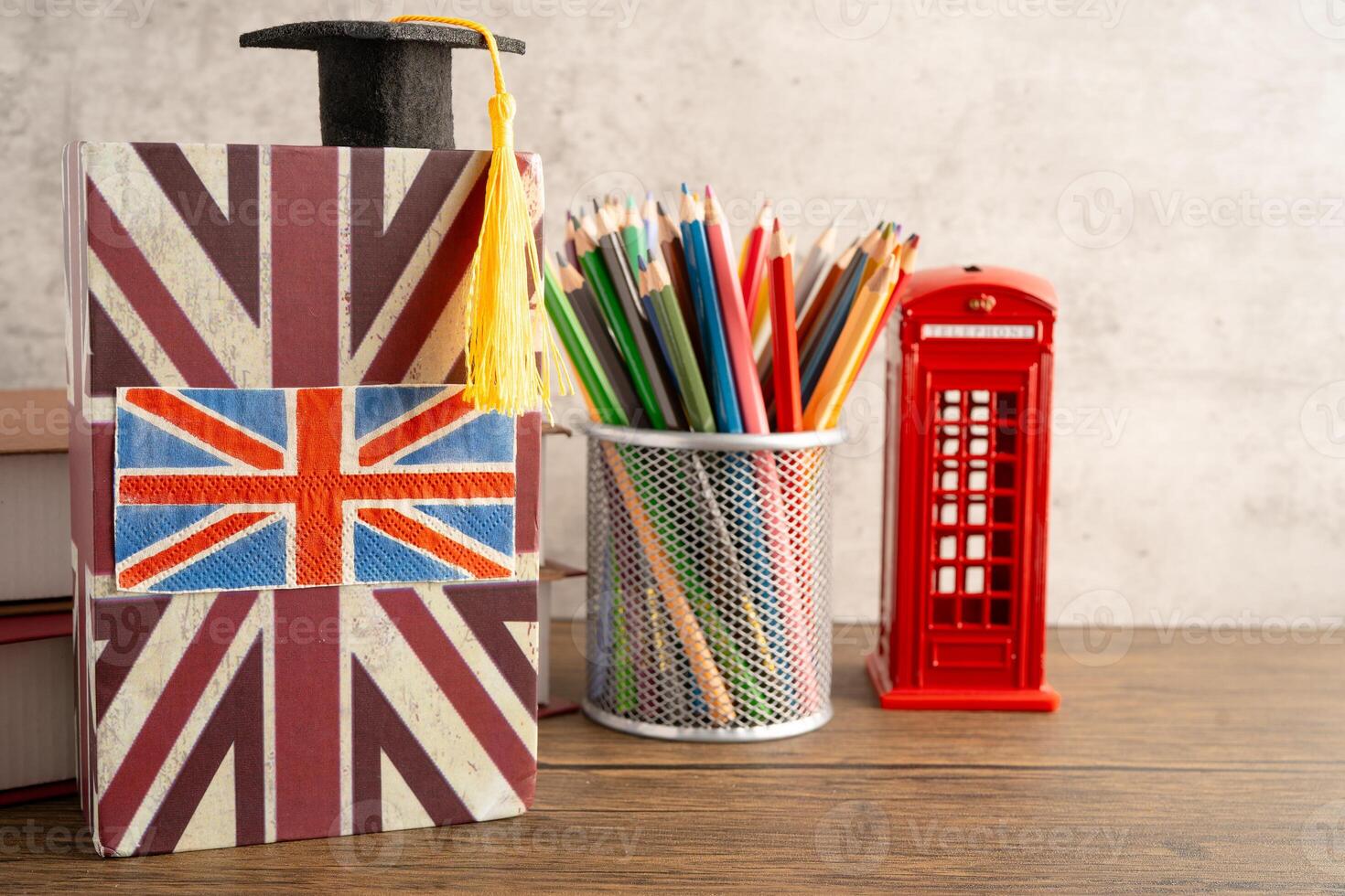 UK flag with graduate hat on english book. photo