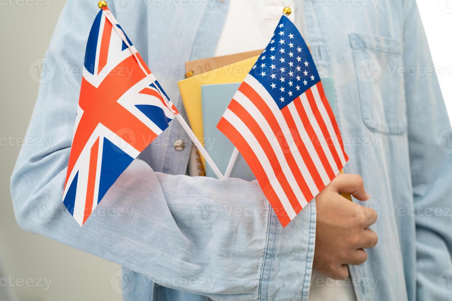 Learn English language Asian teenage student hold book with flag photo