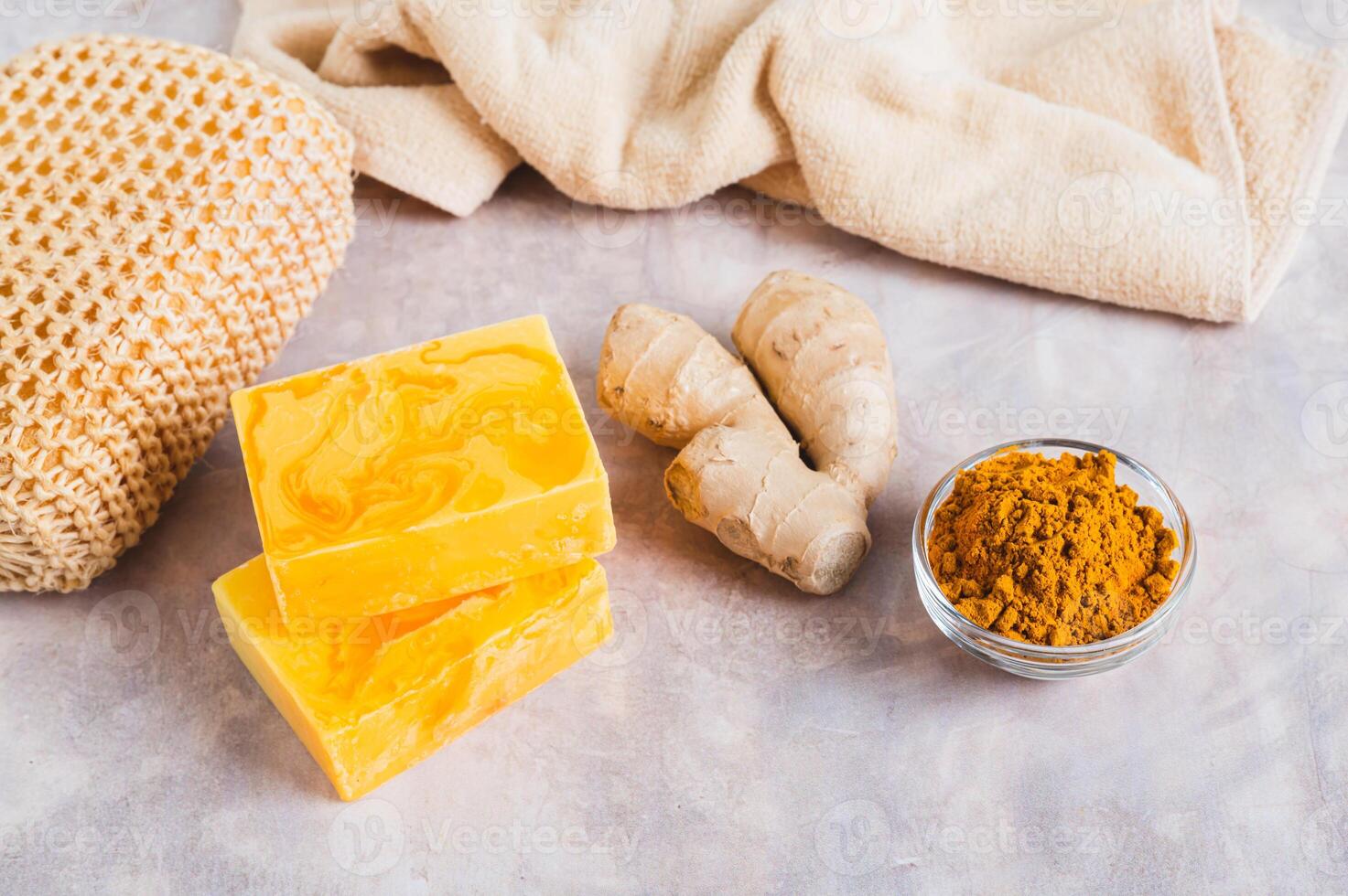 Herbal turmeric soap bars and root on the table photo