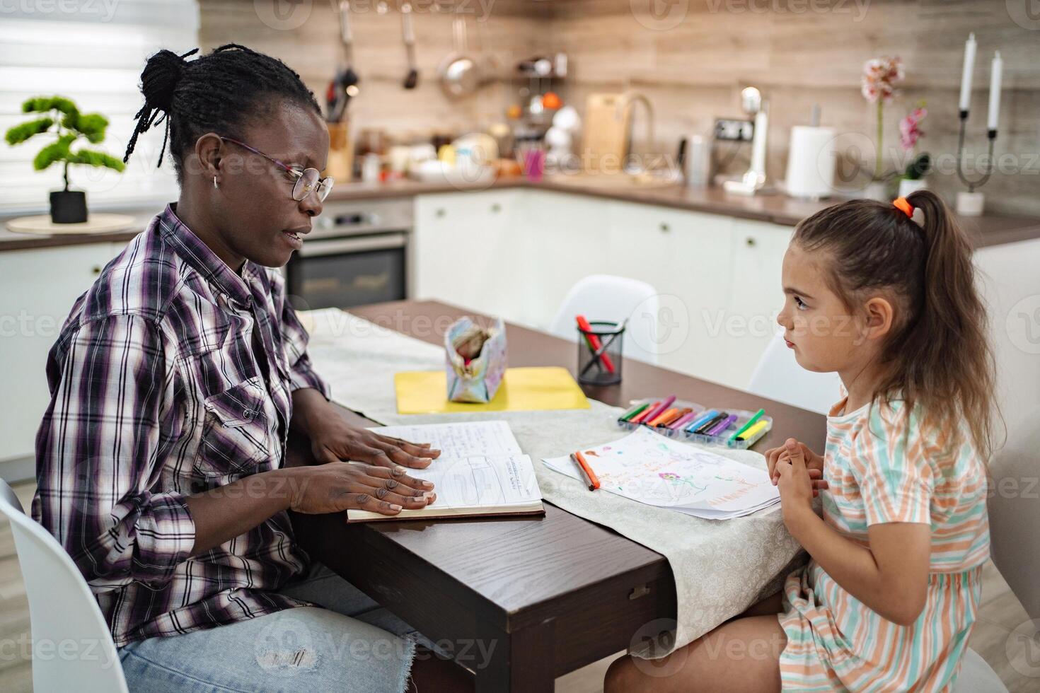Engaging learning moments between a girl and her mentor at home photo