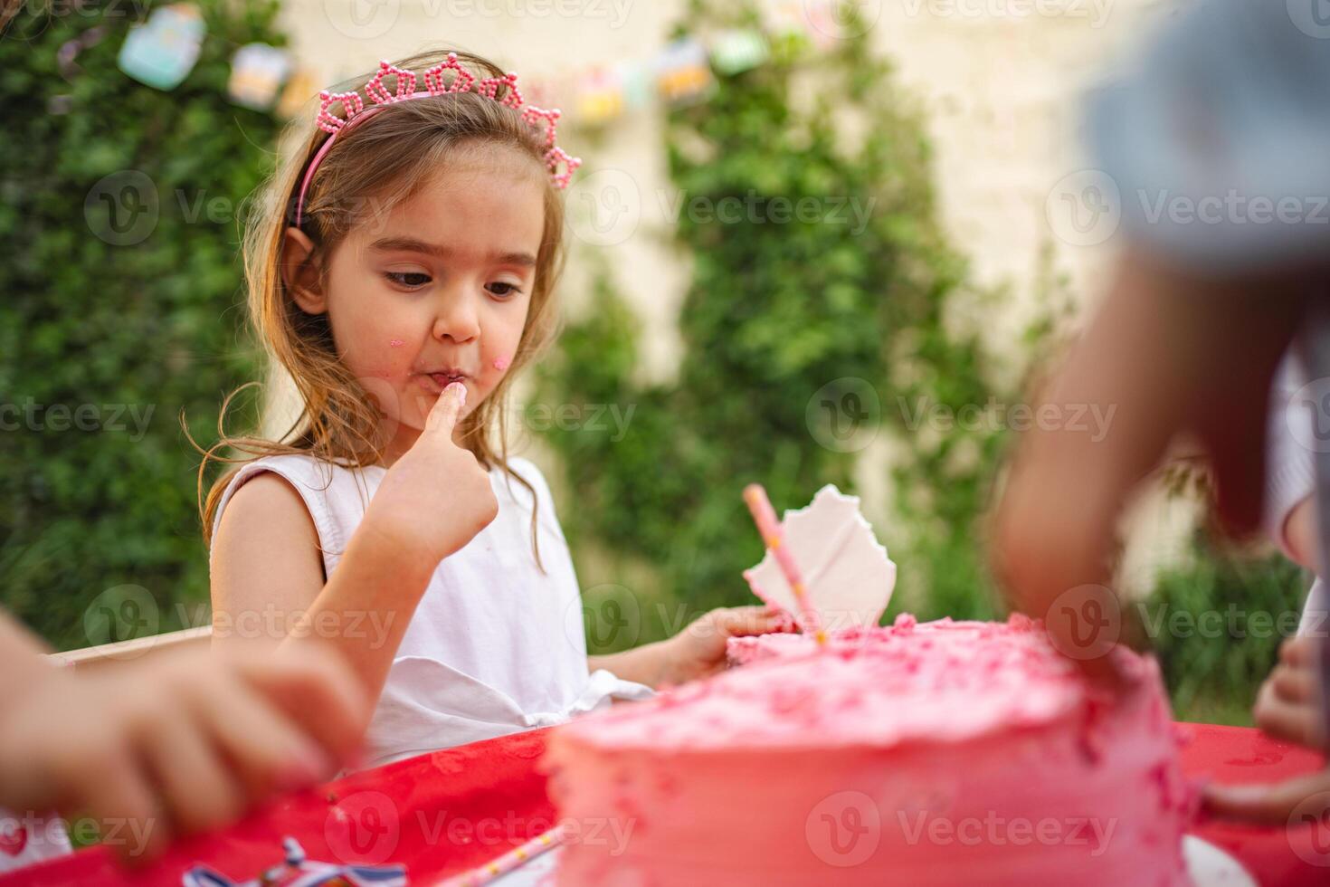Sweet birthday moment with cake and friends at party photo
