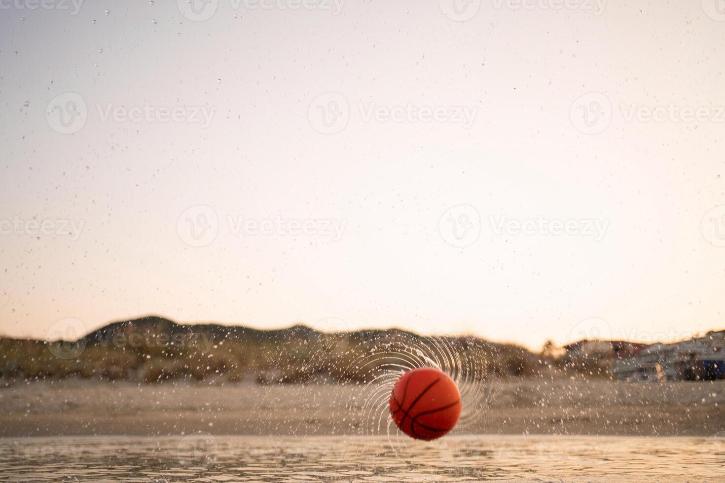 Family enjoys a day of basketball fun at the beach during sunset photo