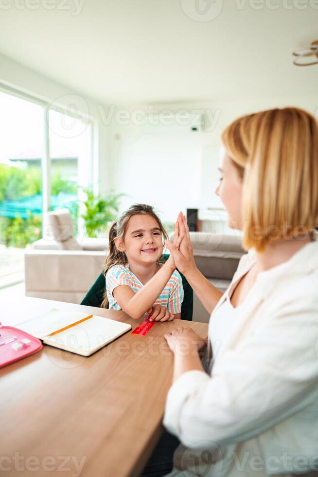 Joyful interaction between child and adult in bright room photo