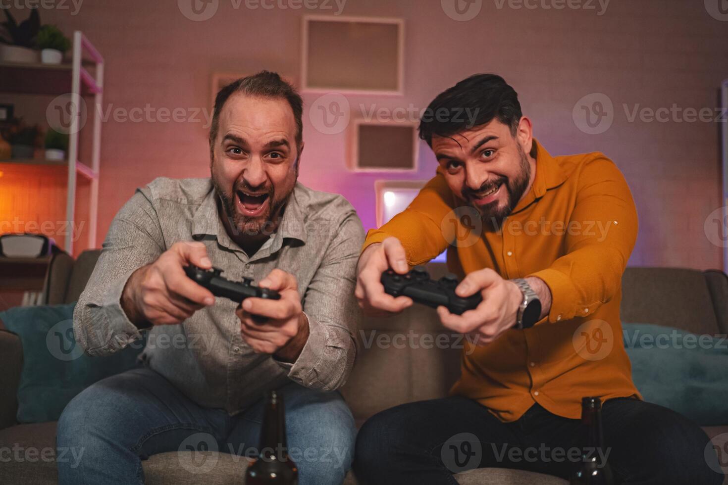 Friends enjoying a lively gaming session in a cozy lounge with drinks on a fun-filled evening photo