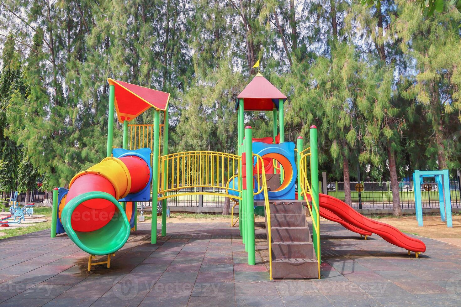 outdoor colorful playground with tree background photo