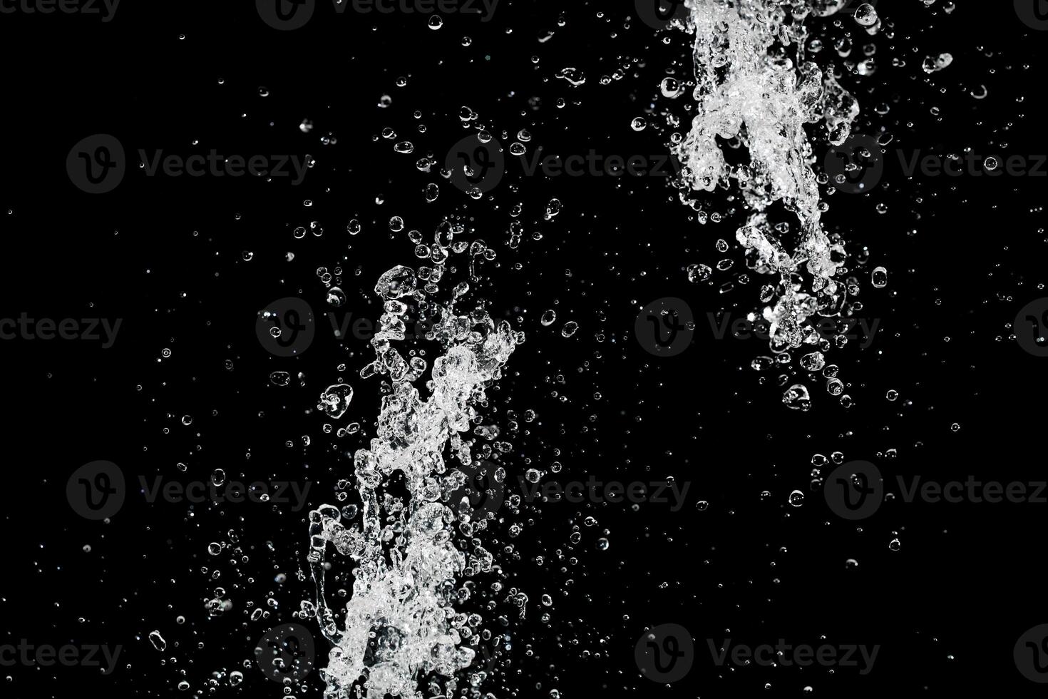 clear water supply splash isolated on black photo