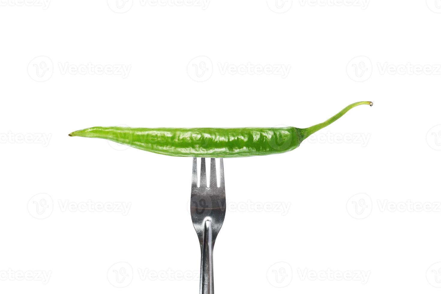 fork pricks green chili isolated on white photo