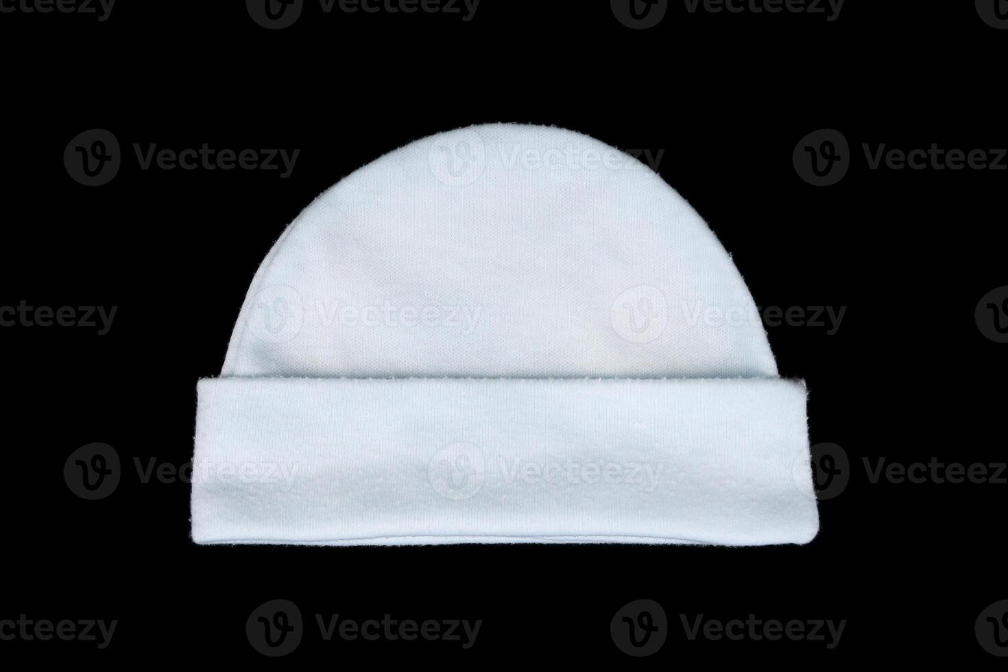 white knitting wool baby hat isolated on black photo