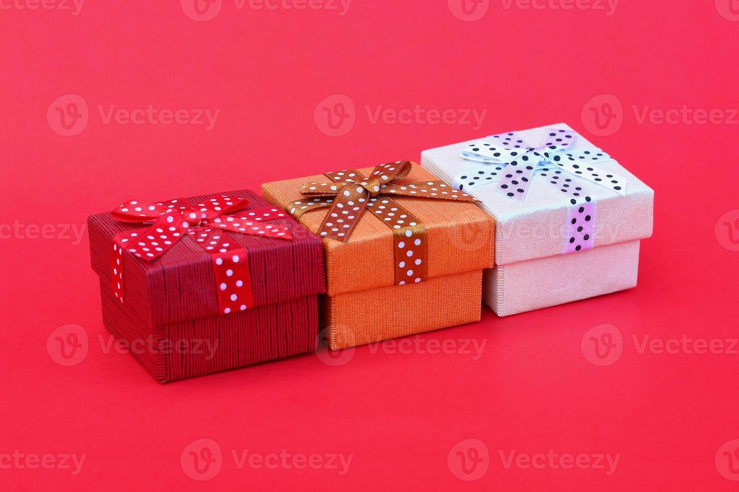 three gift boxes on red background photo
