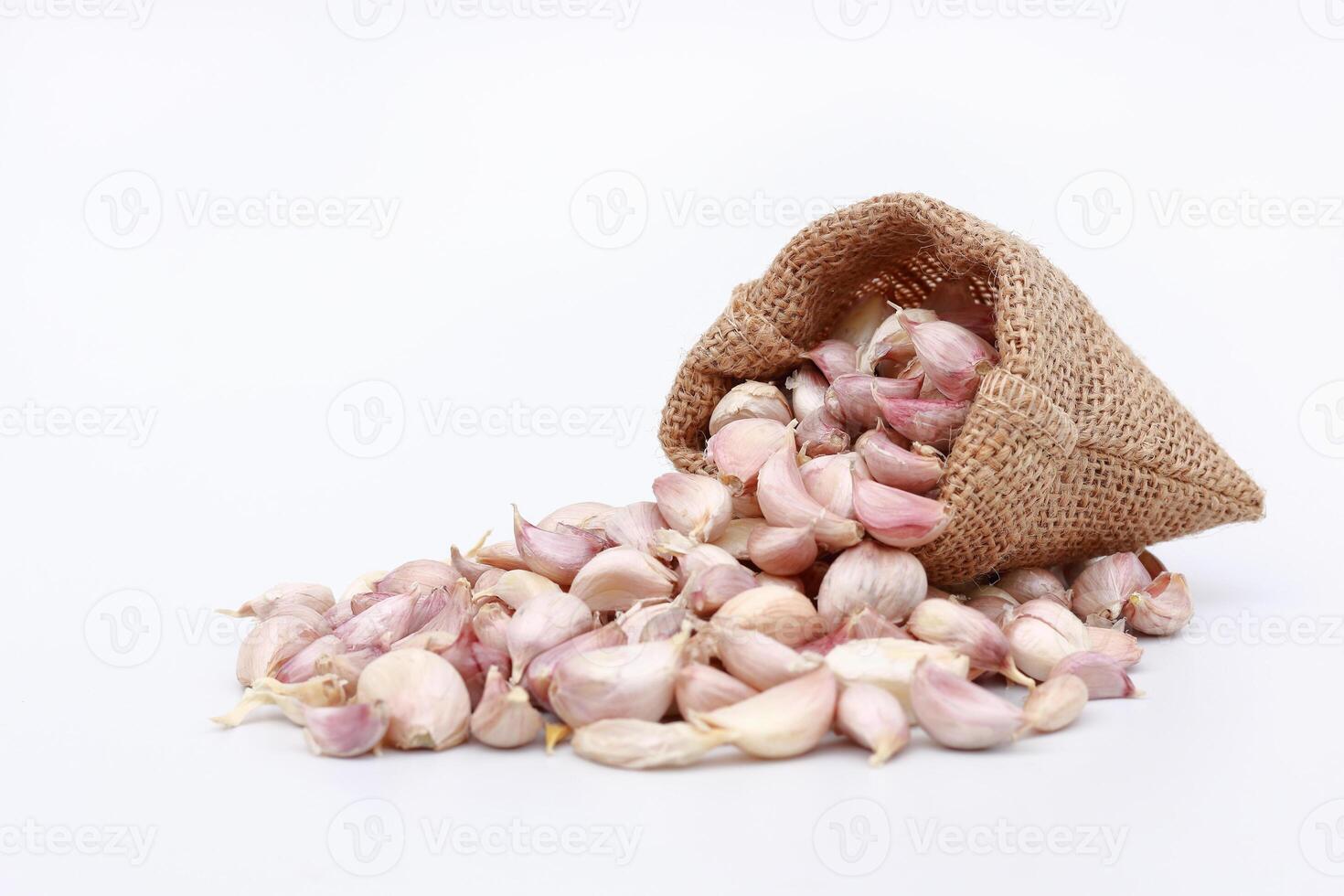 garlic in sack bag on white photo