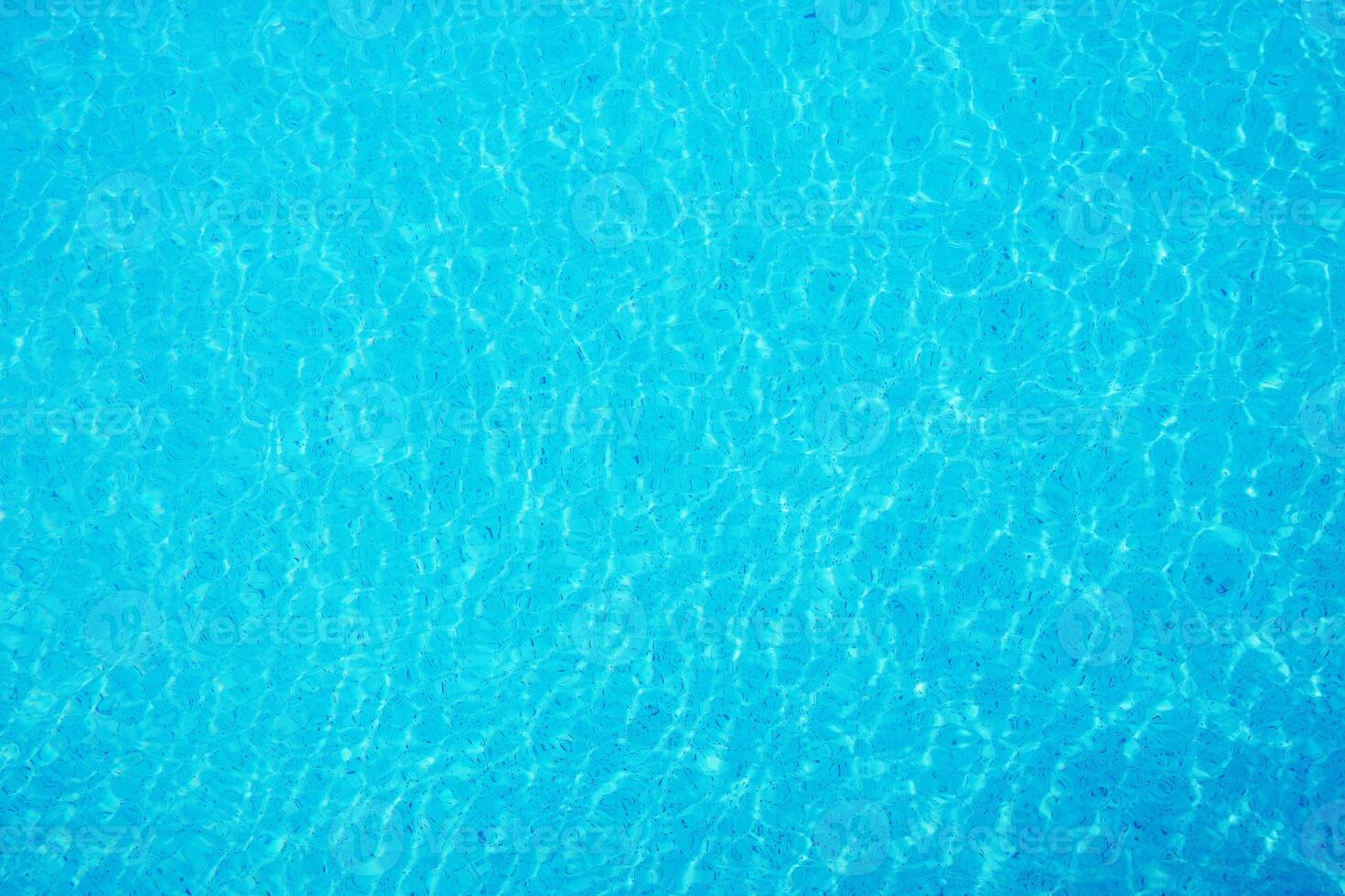 surface of ripple on blue water in swimming pool background. photo