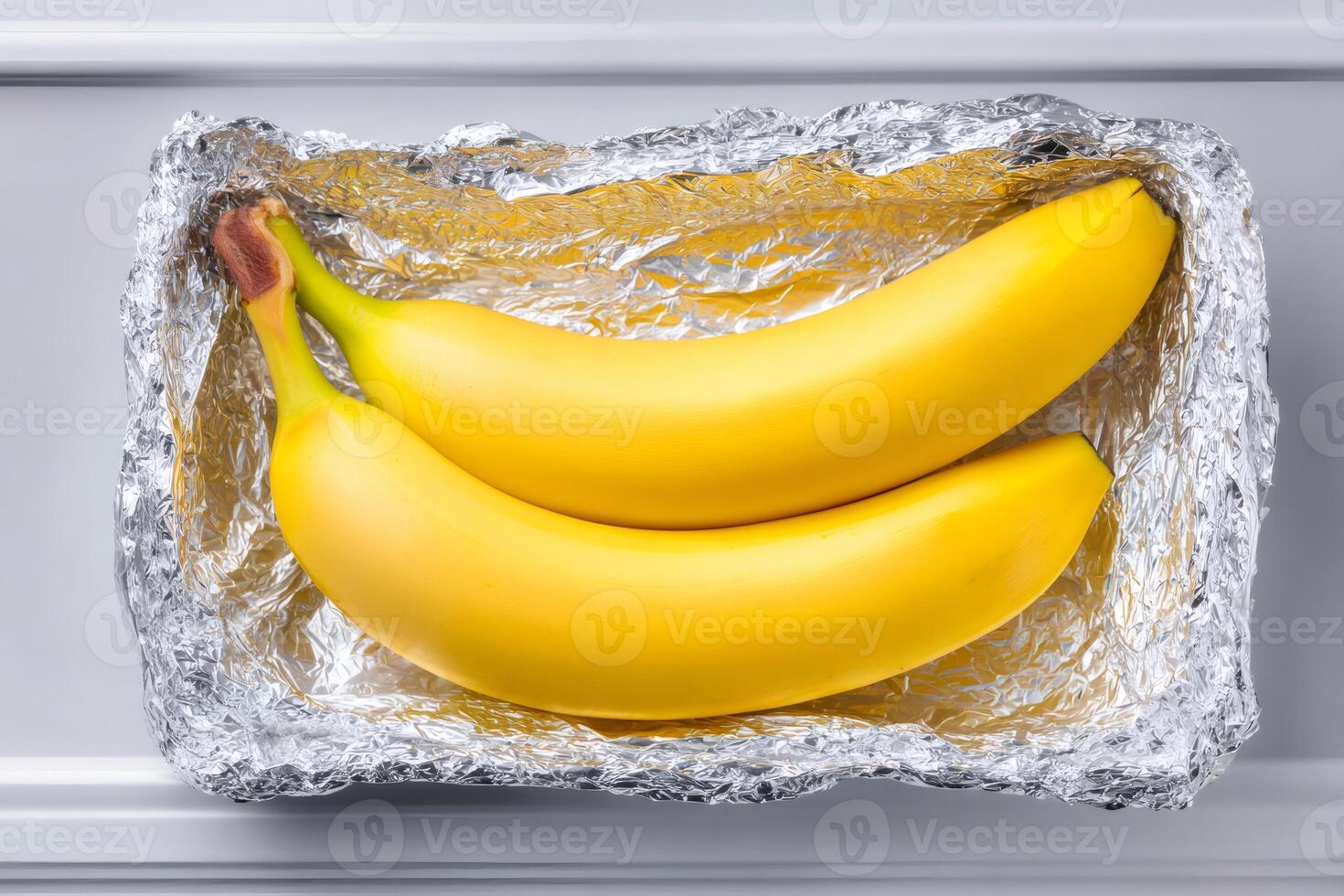 Preserving bananas, wrapping fresh fruit in aluminum foil for extended shelf life photo