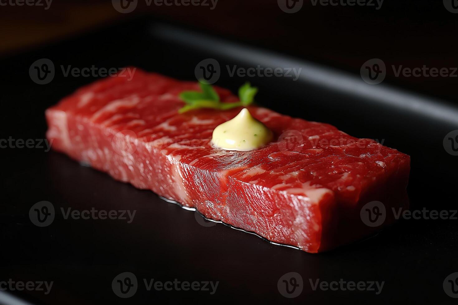 Exquisite wagyu beef with parsley and sauce on elegant black plate photo