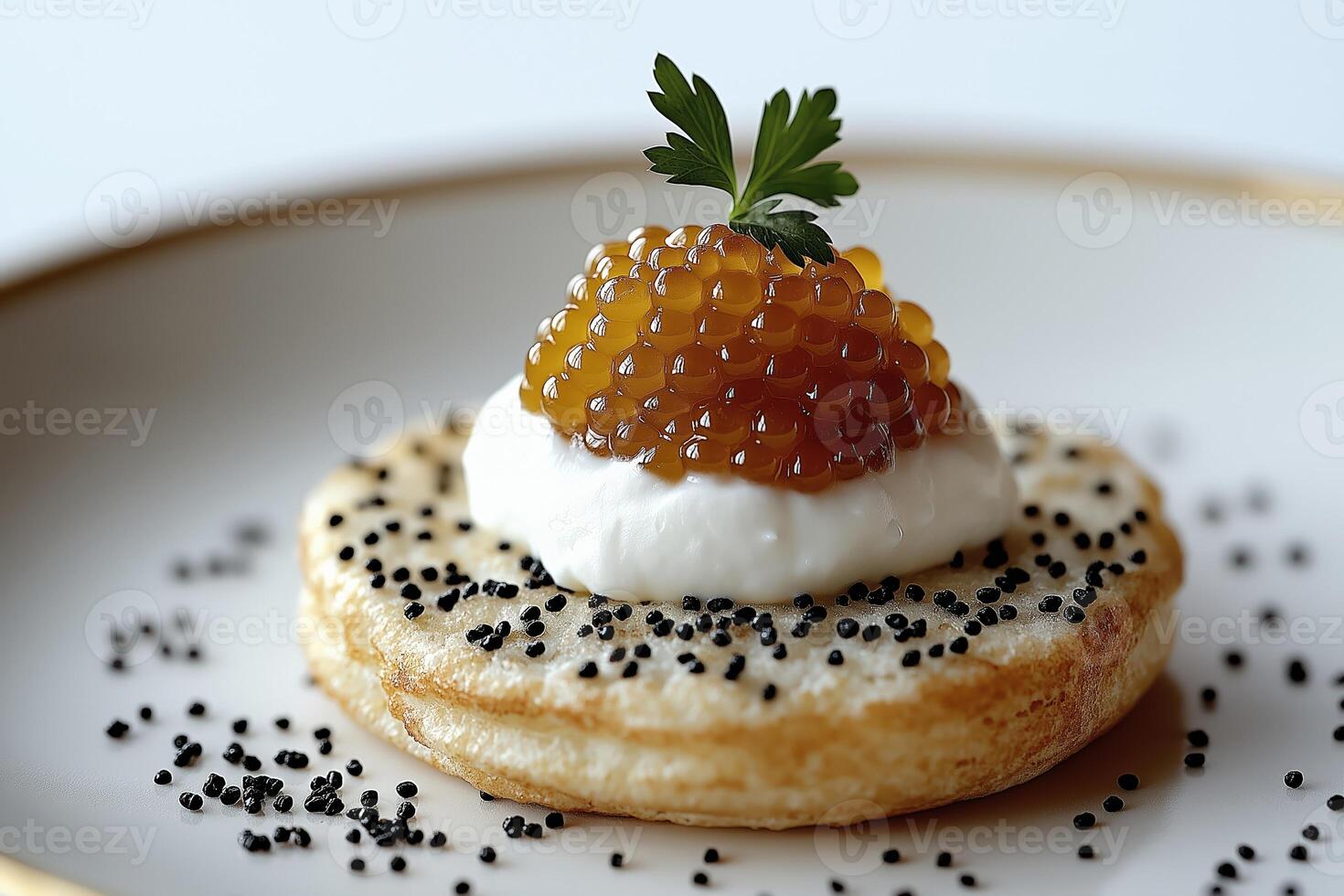 Blinis with sour cream, trout roe and black sesame seeds garnishing a plate photo