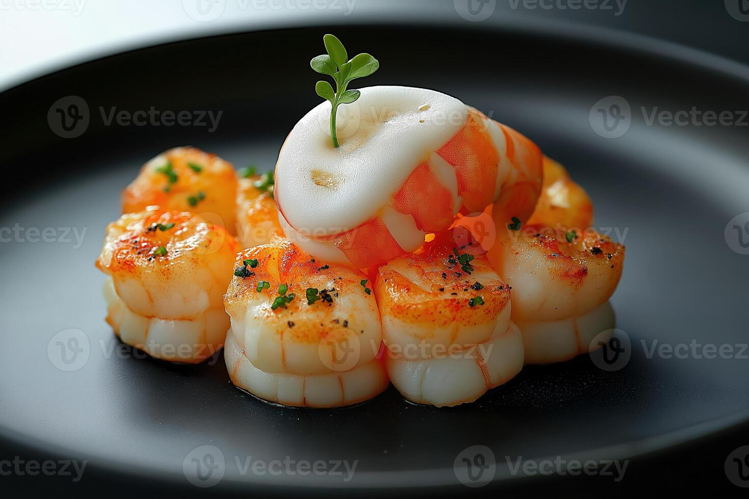 Seared shrimp appetizer garnished with foam and herbs on elegant plate photo