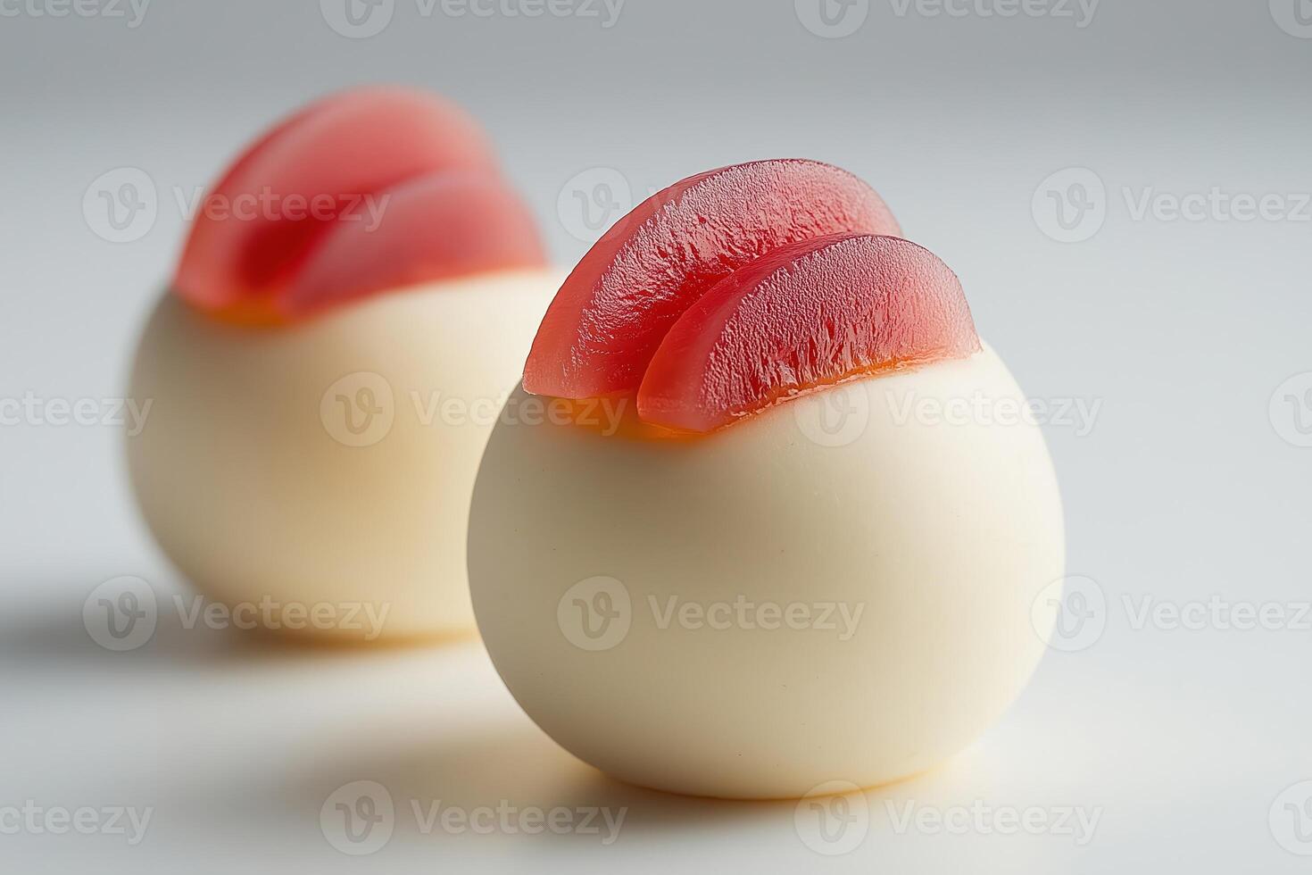 Gourmet dessert presenting slices of candied fruit on a white sphere photo