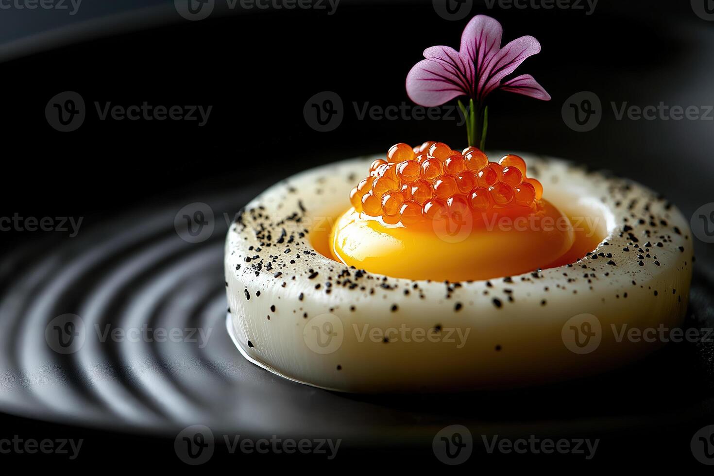 Gourmet egg yolk topped with salmon roe and flower garnish photo