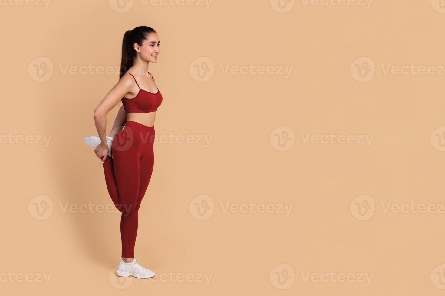 Fitness And Sport. Smiling Slim Young Woman In Sportswear Stretching Leg Before Or After Workout, Warming Up, Doing Exercise Isolated Over Pastel Studio Background. Full Length, Banner. photo