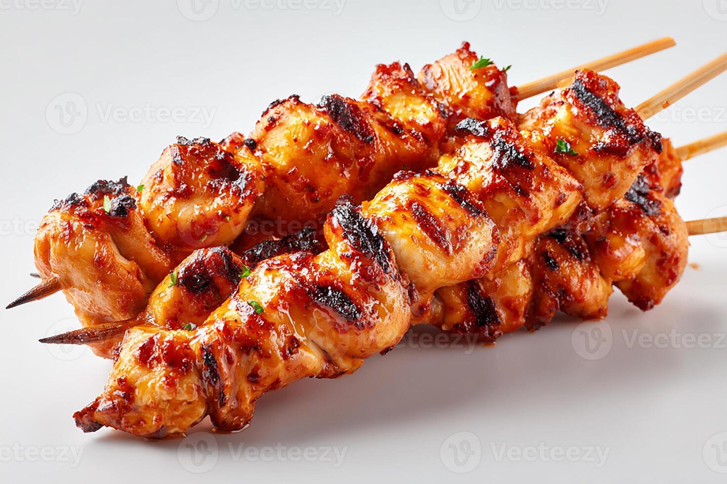 Realistic grilled spicy chicken skewers with char marks served on white background photo