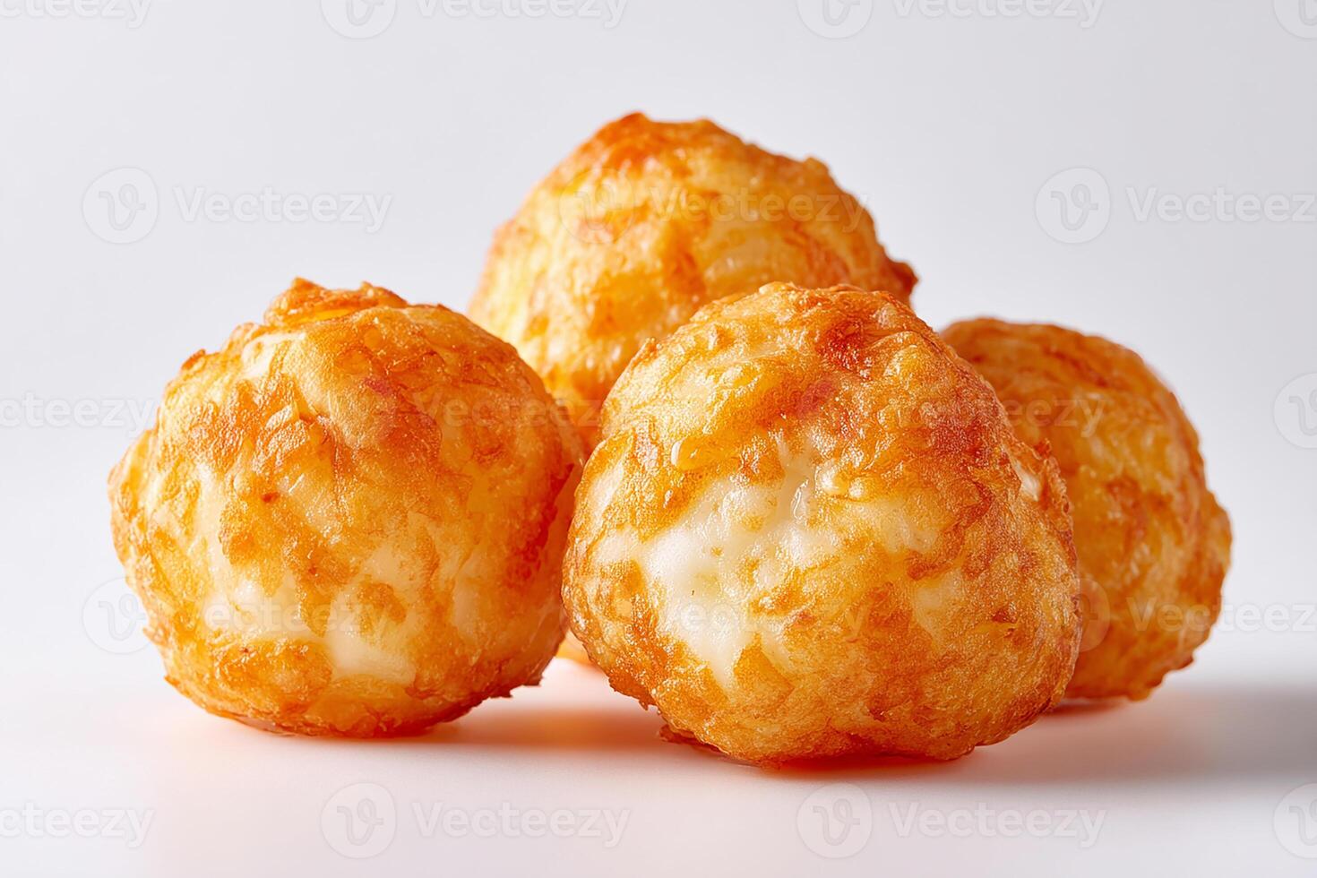 Crispy golden cheese balls deep fried and ready to eat on white background close up photo