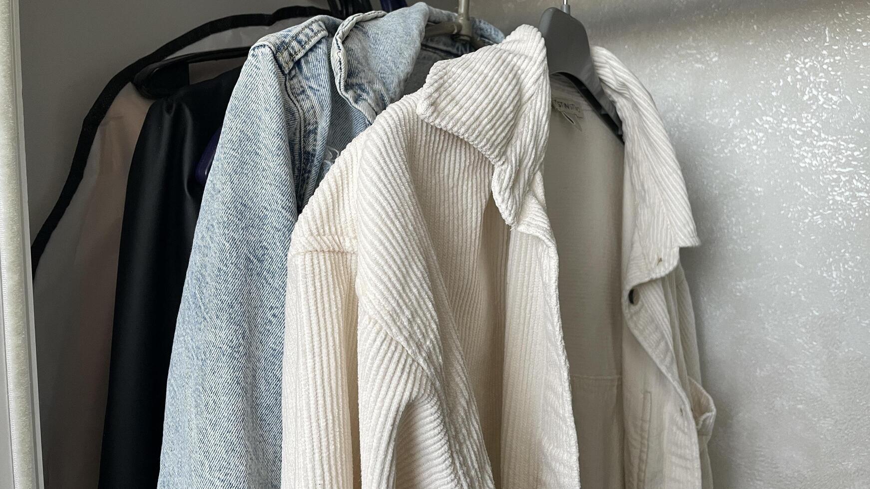 A closet with clothes hanging on a rack photo