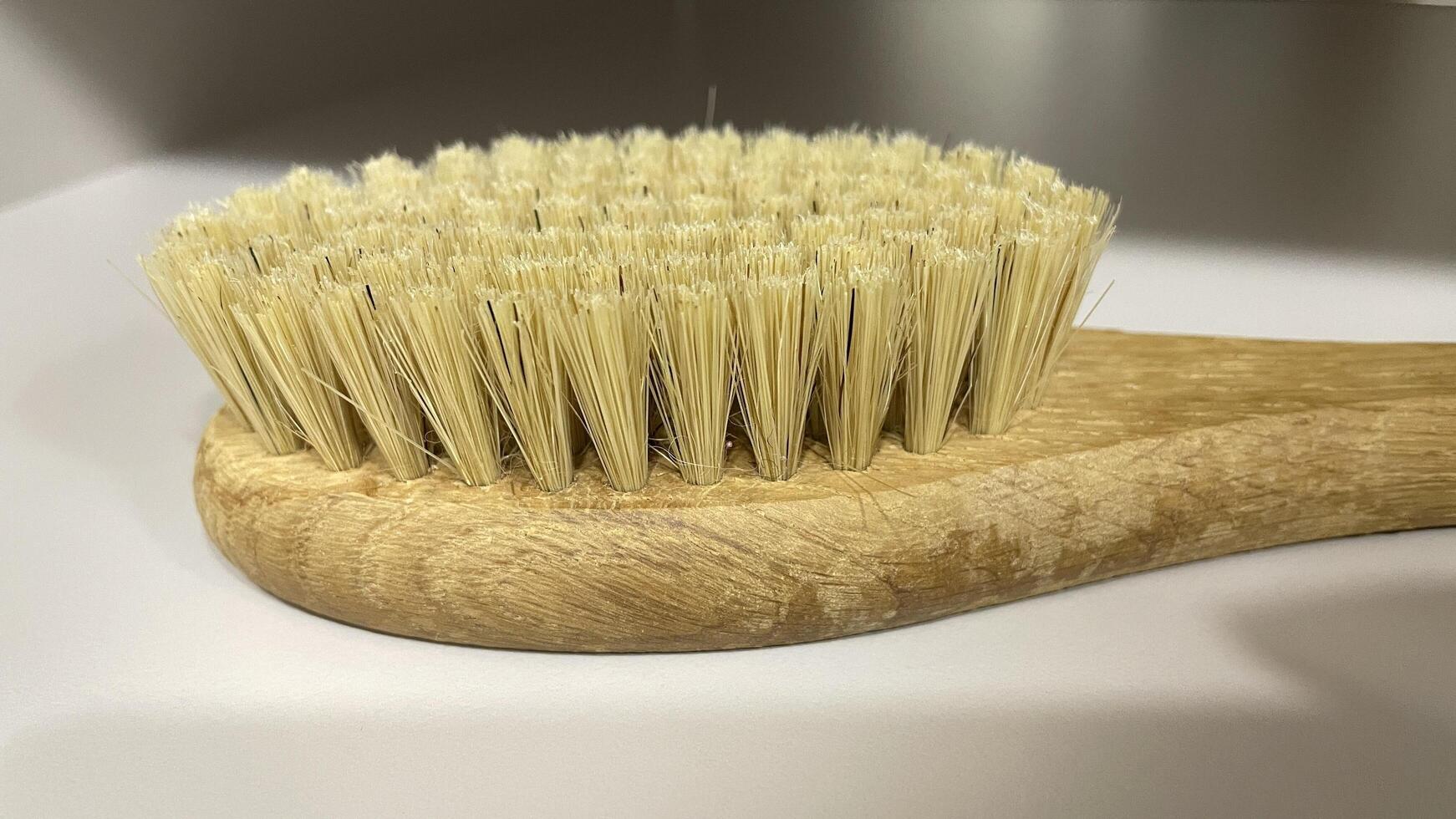 A wooden brush with a wooden handle on a counter photo