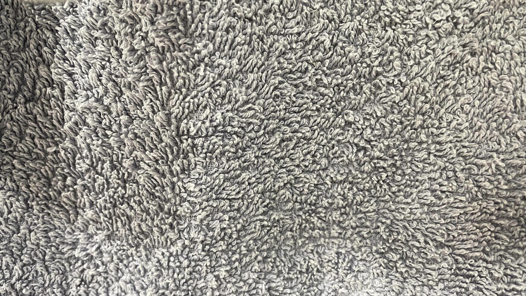 A close up of a gray rug with a white background photo