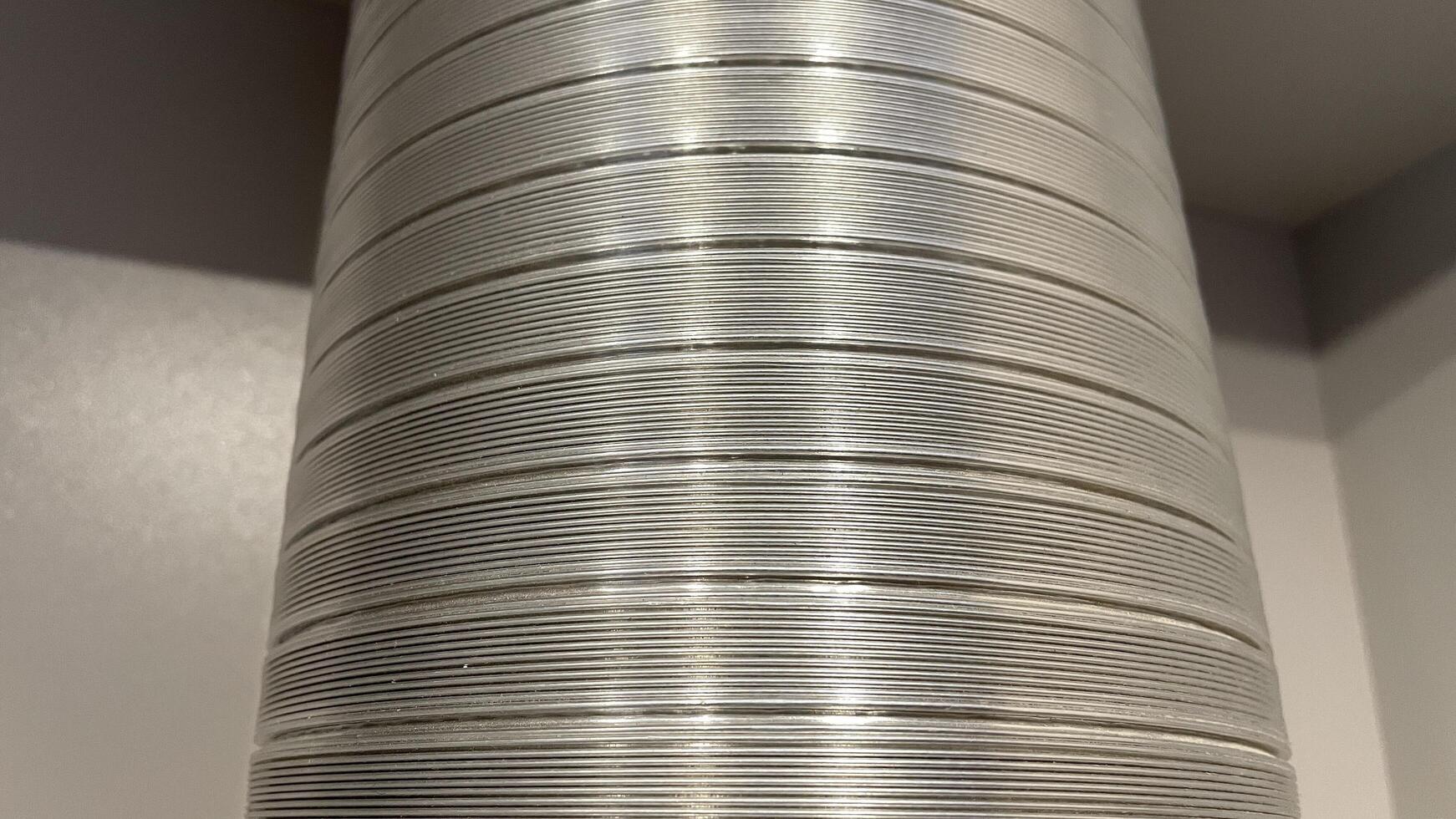 A close up of a metal tube with a white background photo