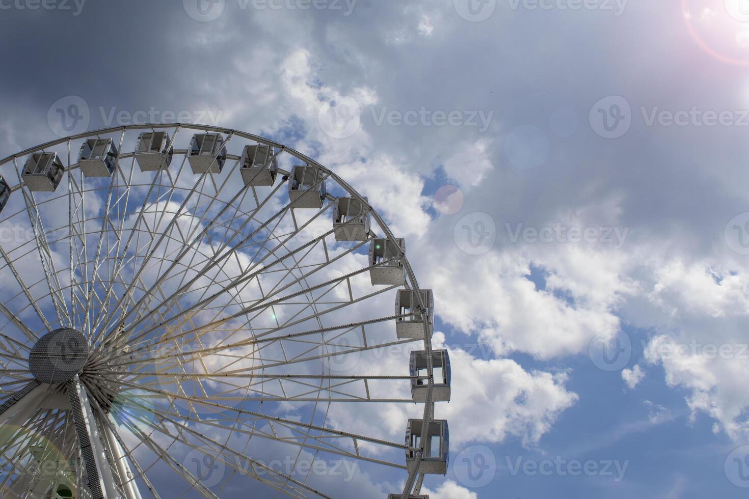 Ferris Wheel Against the Blue Sky. Modern Ferris Wheel photo