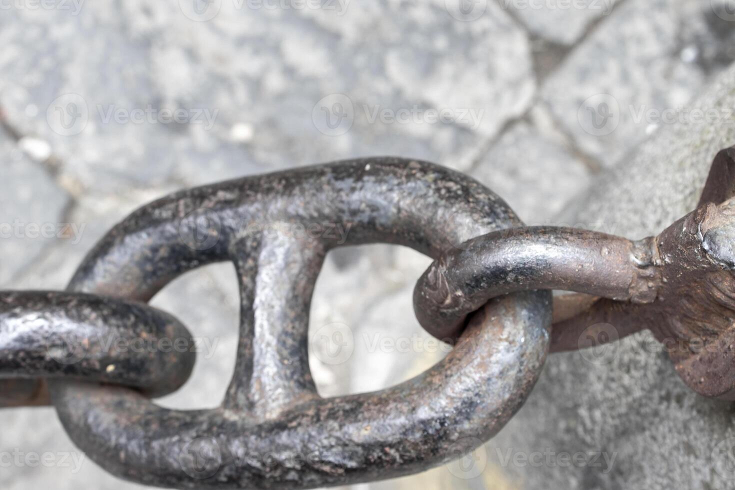 Close-up of an Old Rusty Chain Isolated. Large Chain Links on a Gray Background. The Concept of Bondage and Restriction of Freedom. Slavery. Free Space for Text photo