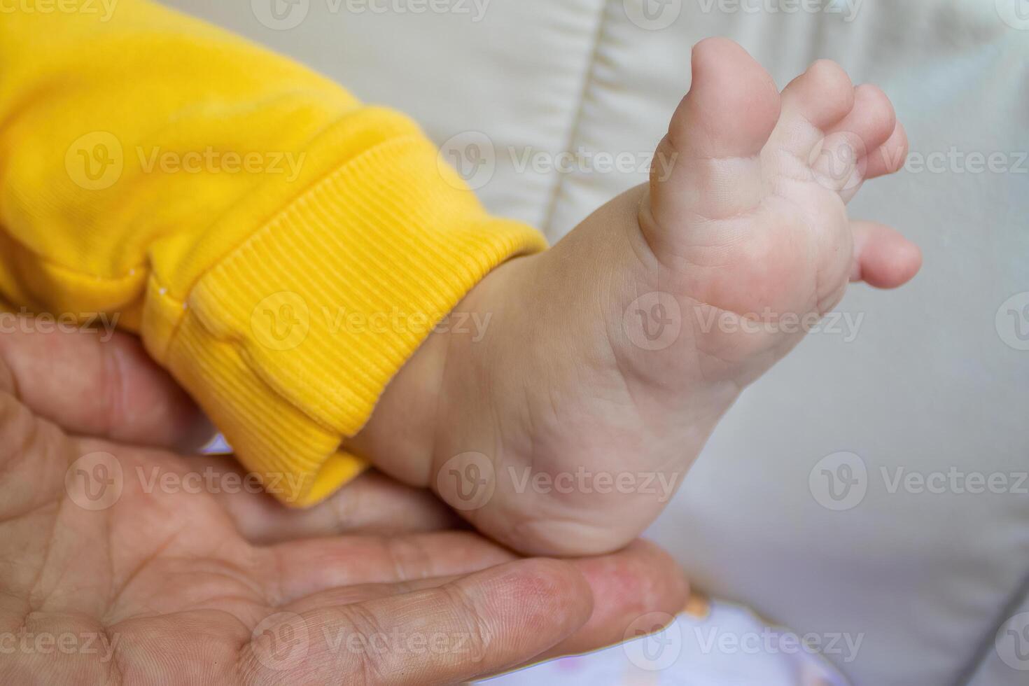 Baby Foot in Mother's Hand. Mom and Her Child. Happy Family Concept. Beautiful Conceptual Image of Motherhood photo