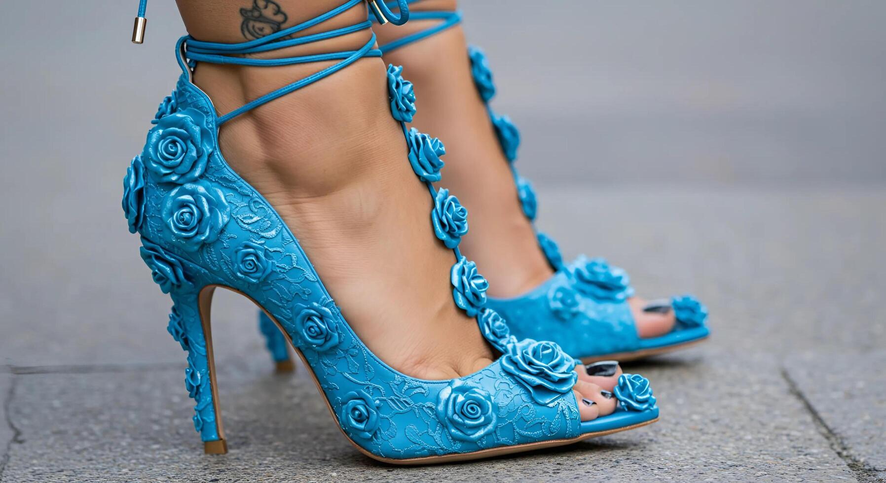 Elegant female legs wearing blue high-heeled shoes adorned with delicate small rose decorations, showcasing a stylish and feminine look with intricate floral details photo