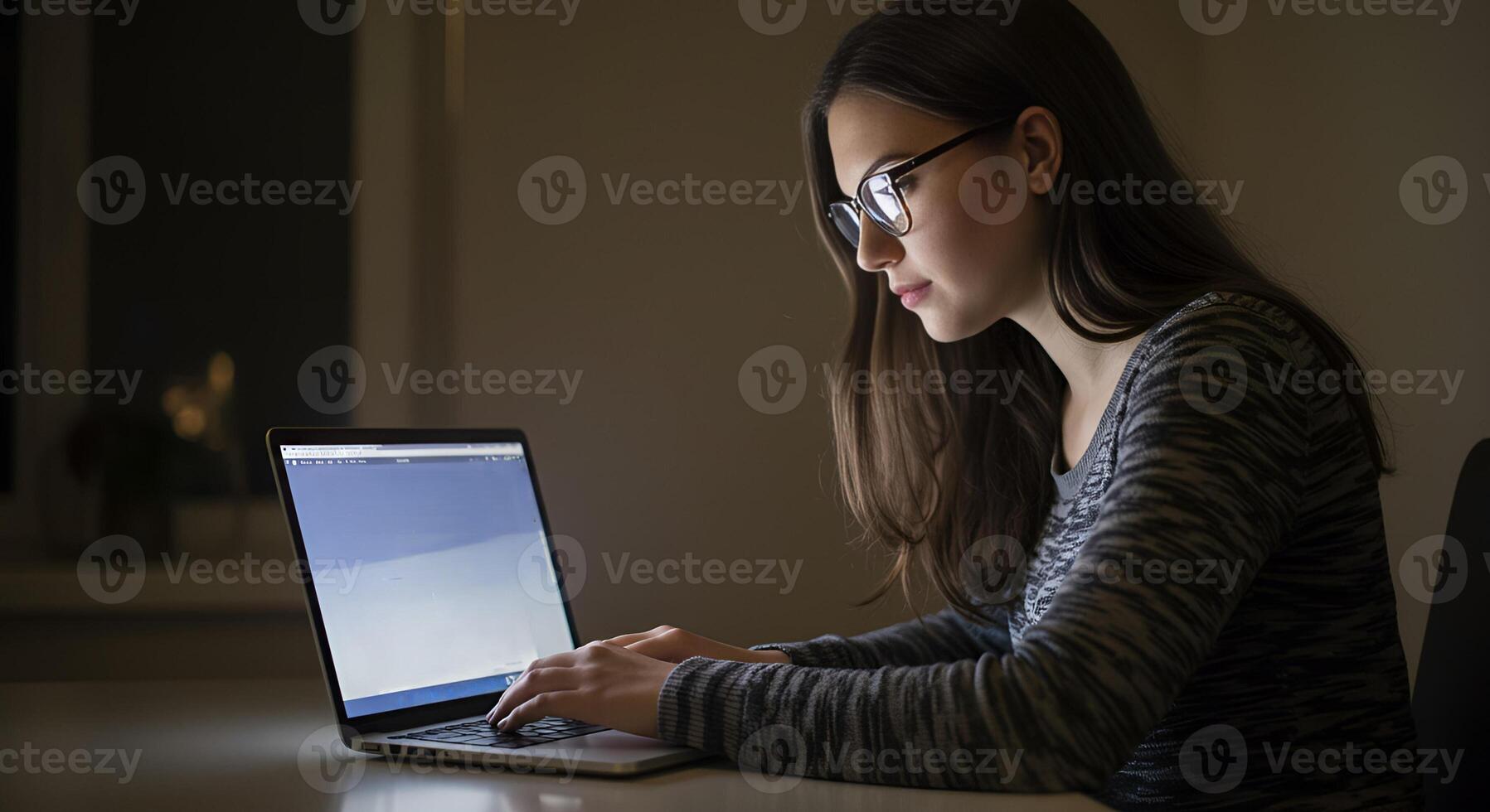 Focused woman using a laptop in a modern setting photo