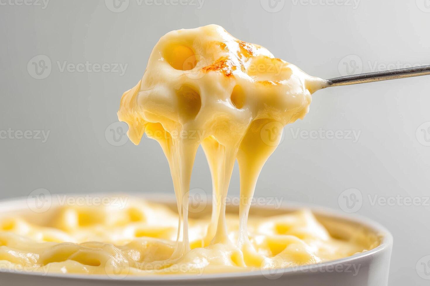 Delicious Cheese Fondue in Bubbling Pot Close-Up photo