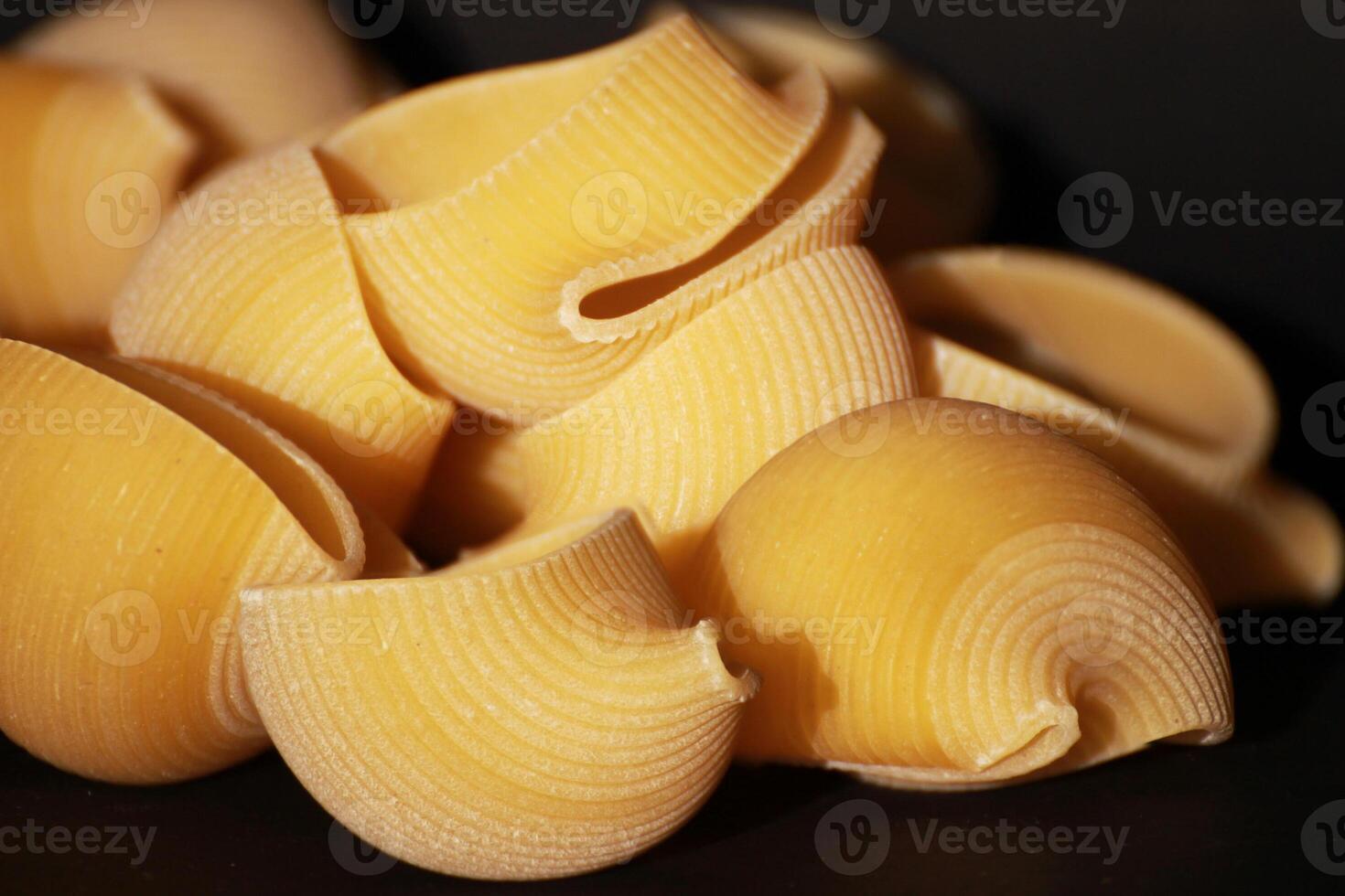 Garofalo Lumaconi Italian Pasta on the black background. photo