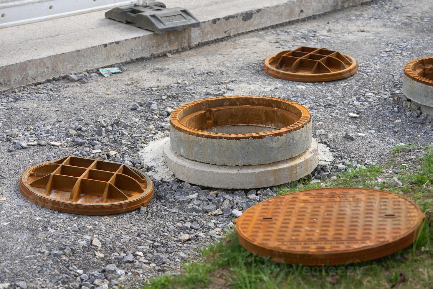 Manhole cover open in street and repair of roads. The use of manholes. Improvement of the city. photo