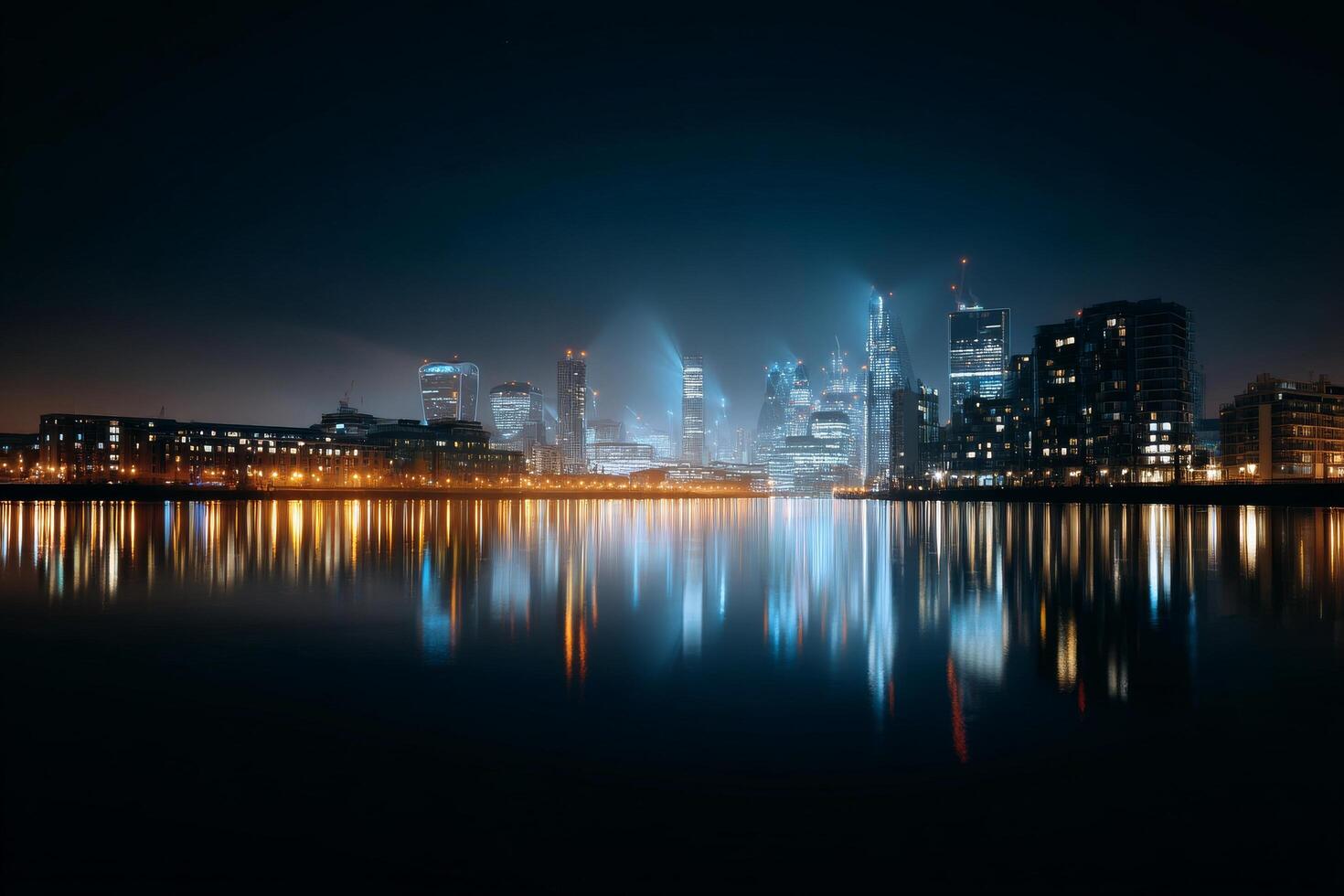 City Skyline Illuminated by Lights at Night With River Reflection and Tall Buildings photo