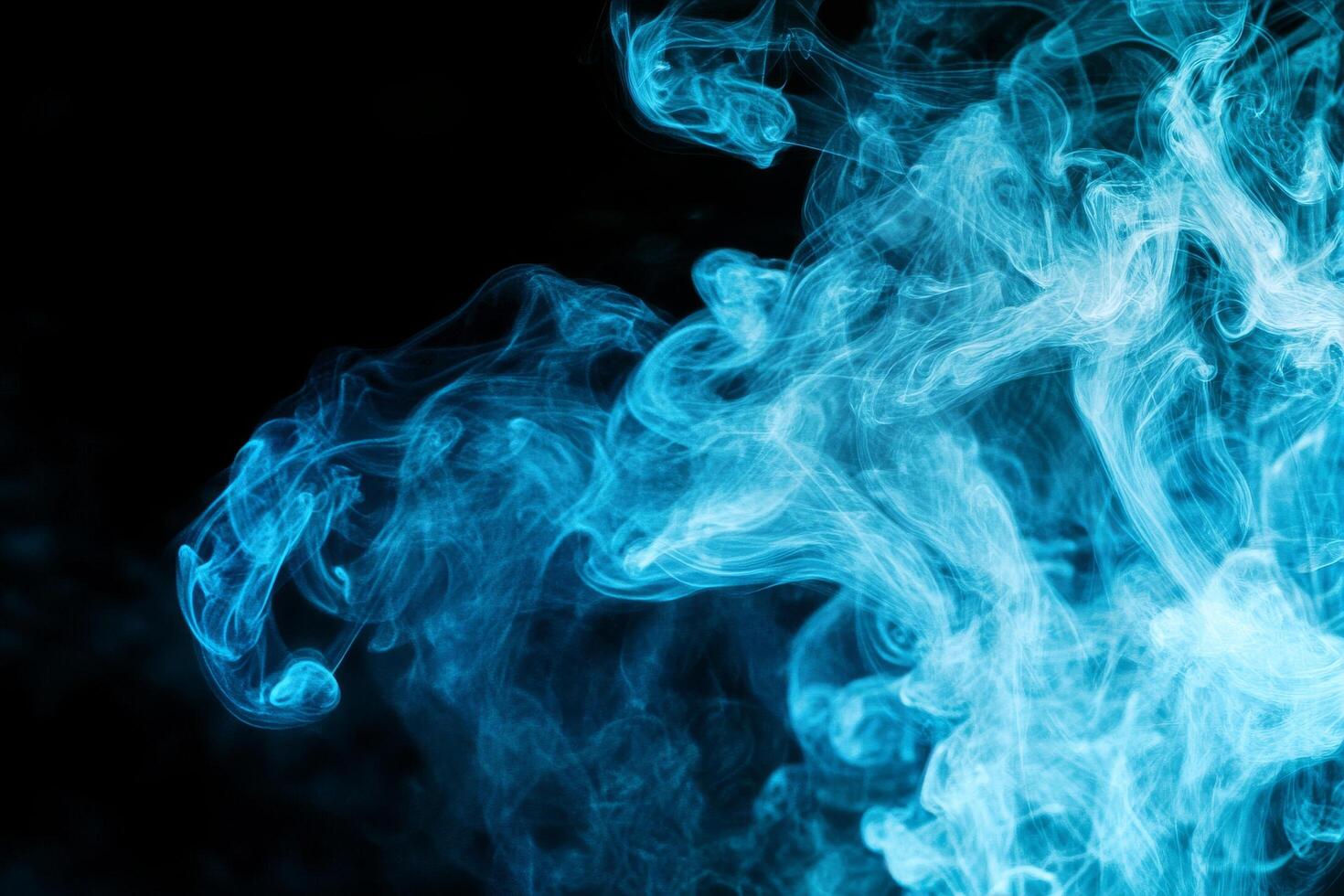 Blue Smoke Swirling in Abstract Patterns Against a Dark Background at Night photo